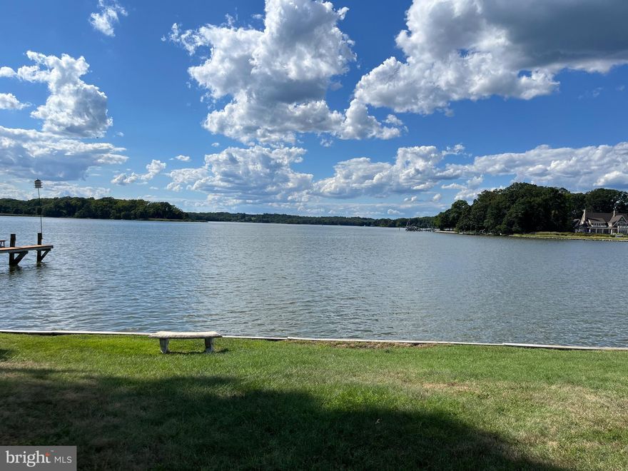Absolutely Charming Coastal Cottage, with one-level living, on a knoll overlooking a wide expanse of the Rhode River. It’s all about the Dynamic Panoramic views! The home was totally renovated in 2015, including enclosing the porch to expand the square footage to about 1440sf. This amenity rich, low maintenance home has just about NEW everything! New shingle-like vinyl siding, new Anderson windows, new doors, new flooring,  new and updated bathrooms, including a large walk-in shower.  Most rooms are painted in a neutral Sand color. The stunning new kitchen is open to the Living and Dining areas as well as the wrap-around water views. The Mud room includes the laundry and plenty of storage.  Also new lighting fixtures, recessed lighting,  ceiling fans, remote controlled LR blinds, new gas fireplace, landscaping and more. The  new Heat Pump/HVAC system includes a Boiler with a hot water coil, providing hot water on demand. The oil tank is above ground and insured. The tall crawl space also has some heating for your extra storage needs. More storage in the attic with pull-down stairs.   The well has a Hydro tank with UV sterilization lights. There is also a water-softener and the home is on public sewer. The gutters are extra wide and have a leaf filter system. The built-in Double ovens are a microwave and oven,  both with convection options and an Induction cooktop. The dramatically large granite topped kitchen island provides a large workspace to spread out on as well as extra dining space. There is also a large pantry off the kitchen. This truly is one-level living thanks to a ramp from the paved driveway to the back doors!
The waterfront is both bulkheaded and rip-rapped. The private road to the Cloverlea Boat Club is a shared easement between the owner and the boat club and was recently paved by the boat club. Sellers will pay the $1800 Club initiation fee with a satisfactory offer. Boat Club has small beach, boat launch and slips available. The Cloverlea Citizens Association is Voluntary at $50/yr.
Forget about Bay Bridge and Rte 50 traffic! This home is an easy lovely drive from the WDC area via 214, off the Beltway and less than 30 minutes South of Annapolis with plenty of shopping areas along the way.
This is an extremely well maintained, well thought out, one level home with fabulous views, just waiting for new owners to enjoy!  Best water views in this price range! “Live where you love and love where you live!”
