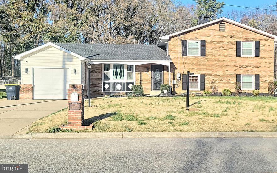 This charming split-level home in the desirable Westchester neighborhood offers a perfect blend of comfort and style. With 4 spacious bedrooms and 3 full bathrooms, this residence is designed for both relaxation and entertaining. Step inside to discover an inviting open floor plan, featuring beautiful wood floors and elegant chair railings that enhance the warmth of the living space. The main level features an expansive living room, conveniently located off the kitchen, offering windows that wrap around the space to create a light-filled, airy room that is perfect for everyday living as well as formal gatherings.  The fully finished basement, complete with a walkout entrance, provides additional living space and versatility that is ideal for a home office, game room, or extended entertainment area. Cozy up by the brick fireplace, a charming focal point that adds character to the home. This is the perfect home for outdoor enthusiasts. The property sits on a generous level lot, nearly a half acre in size, that is cleared, beautifully landscaped, and which backs to trees. The picturesque yard is complemented by two extremely large patios, including one custom-built brick patio, which create the perfect setting for summer barbecues or quiet evenings under the stars. The attached garage and ample driveway parking ensure convenience for you and your guests. While the home is more than aesthetically pleasing, it offers numerous value-added features including updated windows, a newer roof, and newer HVAC system. If these features aren't enough, wait until you see the huge sunroom - it's absolutely fabulous!!! The space is perfect for crab feasts, watching snow fall, outdoor dinner parties, or add a hot tub and turn it into your personal spa. With so many possible uses, the sunroom is sure to become your favorite place in the home. Located in a vibrant community, residents benefit from nearby parks, schools, multiple public service agencies, and easy access to main highways, Branch Ave metro station, and public transportation. Explore local amenities, including shops and dining options, all within a short drive. This home is not just a place to live; it truly is a place to thrive. This delightful property offering so much value for such a competitive price, won't last long. Schedule your viewing today! PROPERTY  HAS VIDEO SECURITY CAMERAS.  PLEASE DO NOT ENTER PROPERTY WITHOUT LICENSED AGENT AND/OR APPOINTMENT.