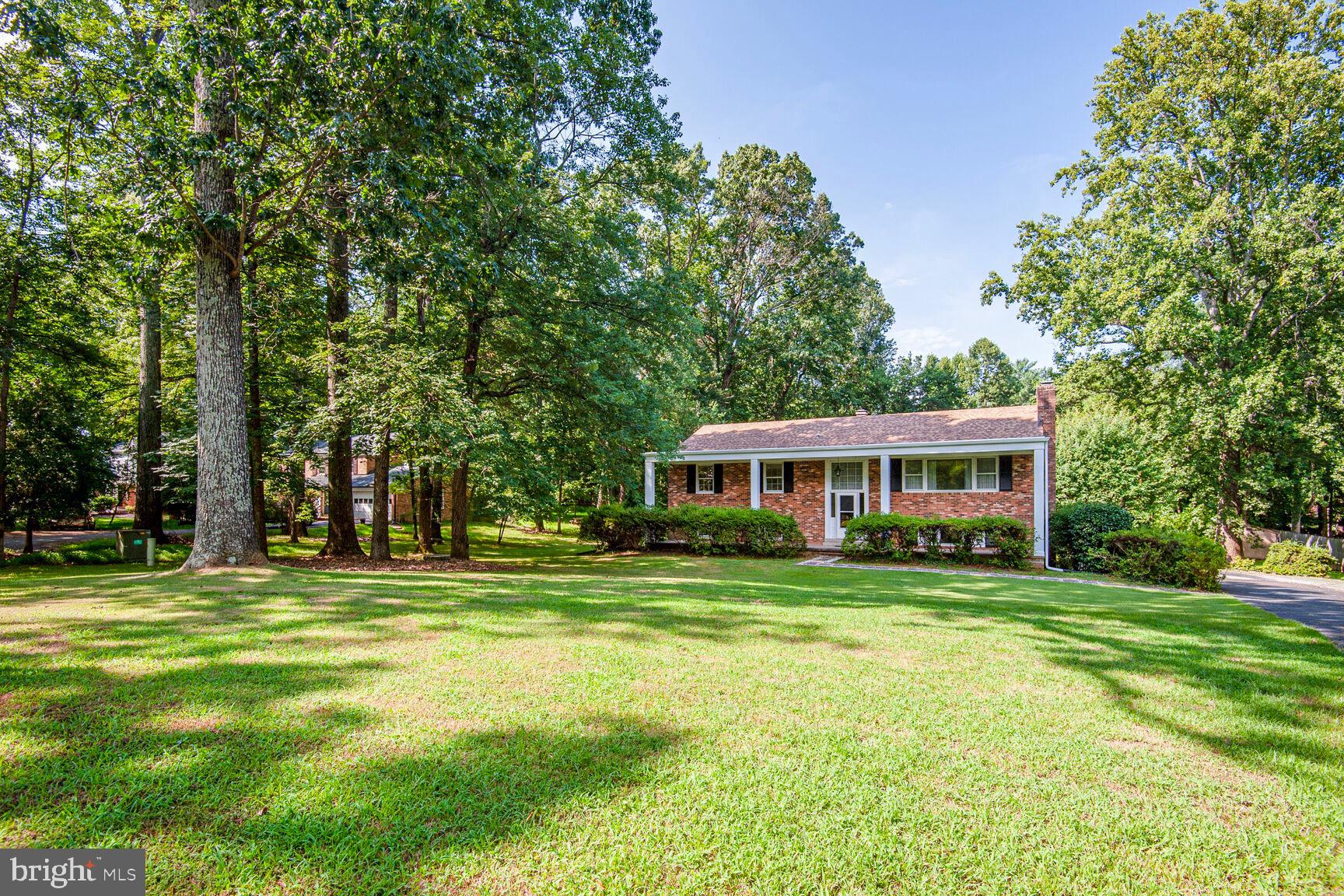 Welcome to this all-brick estate nestled on prestigious Vale Road in highly sought-after Oakton, Virginia—one of the most exclusive and admired streets in the area, known for its collection of multi-million dollar custom homes. Situated on a beautifully landscaped and level .95-acre lot, this stately residence offers timeless elegance, modern updates, and exceptional investment potential.
Set back from the street and framed by mature azaleas, lilac, forsythia, and other flowering trees, the home makes a commanding first impression with its classic covered front porch, distinguished by grand columns and a low-maintenance vinyl-wrapped exterior.
Inside, you’ll find five spacious bedrooms and three full bathrooms thoughtfully designed across a traditional yet functional floor plan. The main level features gleaming wood floors and massive picture windows that fill the home with natural light. A wood-burning fireplace adds charm and warmth to the upper-level living room, while a second fireplace anchors the lower-level recreation room, which also features custom built-ins for stylish and practical storage.
The kitchen and dining rooms offer direct access to a large custom deck, perfect for outdoor entertaining or quiet mornings surrounded by nature. The lower level includes a spacious laundry and mudroom with built-in shelving and an additional large closet, offering convenient access to the backyard. A one-car garage adds functionality, and the expansive lot provides room for potential future expansion.
Recent updates include a new roof and a new water heater, enhancing both peace of mind and long-term value. Lovingly maintained by long-term owners, this home is filled with warmth, character, and pride of ownership.
Located just minutes from Vienna, Fair Oaks, and major commuter routes, and zoned for top-rated schools, this exceptional property presents a rare opportunity to own on a street long associated with distinction and desirability. Whether you are seeking a forever home or a strategic investment, this residence delivers unmatched value in a premier location.