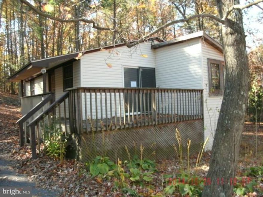 Wonderful 4+ acre lot with cleared front yard and wooded back. Privacy galore. Wonderful setting and large garage. Home needs repair but would be a great get away home.  Only a few miles from commuter route 9 but another world to relax and enjoy the peace and quiet. Seller will pay up to $500 for Home Warranty for owner occupant buyer. Multiple offers received.