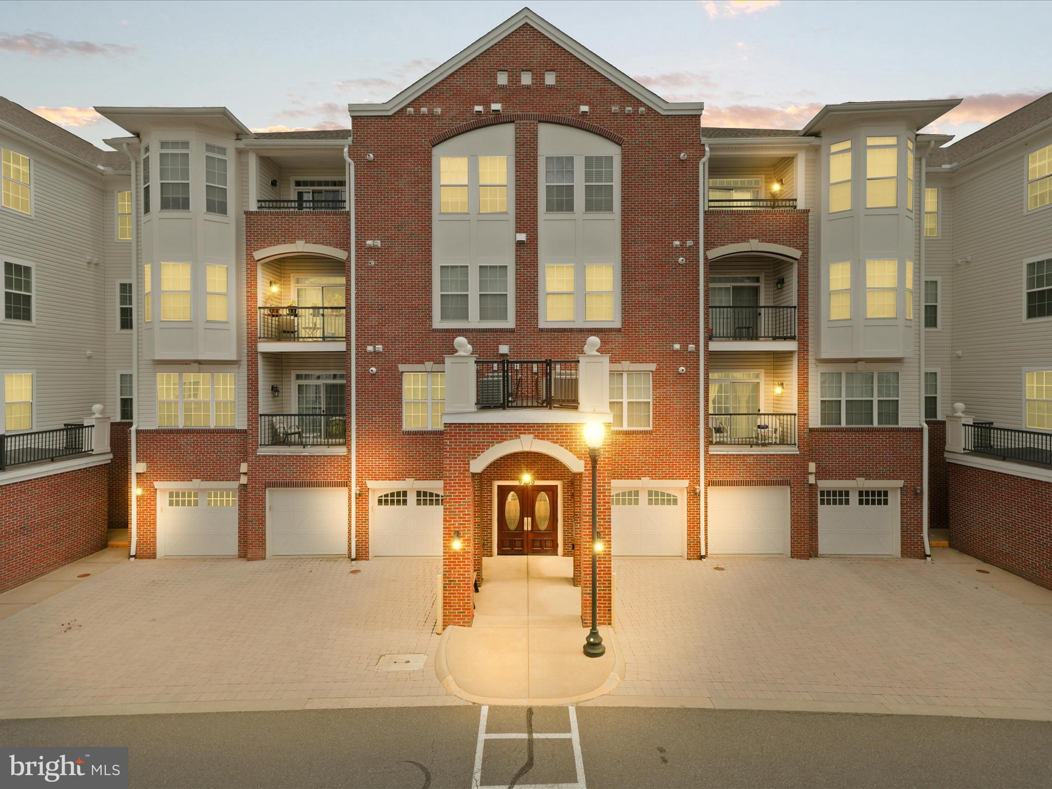 Experience luxurious one-level living in this beautifully maintained 55+ active adult community and low maintenance lifestyle! Situated on the third floor of a secure building with controlled entry and convenient elevator access, this spacious unit boasts soaring ceilings and abundant natural light streaming through numerous windows. Hardwood floors flow throughout the expansive living areas and generously sized bedrooms, creating an inviting and elegant atmosphere.
The chef-inspired kitchen features granite countertops, a stylish backsplash, stainless steel appliances, and ample space for a cozy breakfast nook. Elegant, updated light fixtures add a refined touch to every room.
Retreat to the spacious primary bedroom complete with a luxurious ensuite bath, offering dual vanities, a separate shower, and a large walk-in closet. The secondary bedrooms are well-sized and versatile, perfect for guests or hobbies. Enjoy the convenience of a full-size laundry room within the unit.
Step out onto your private balcony off the living room, overlooking peaceful, private surroundings. This residence also includes an attached one-car garage with direct interior access to the building, providing added convenience and security.
The community is filled with amenities including outdoor and indoor open spaces, clubhouse with fitness center, tennis courts.
Prime location to commuter routes, minutes from restaurants, shopping and Old Town Manassas, VRE and local community events. This is a must see!