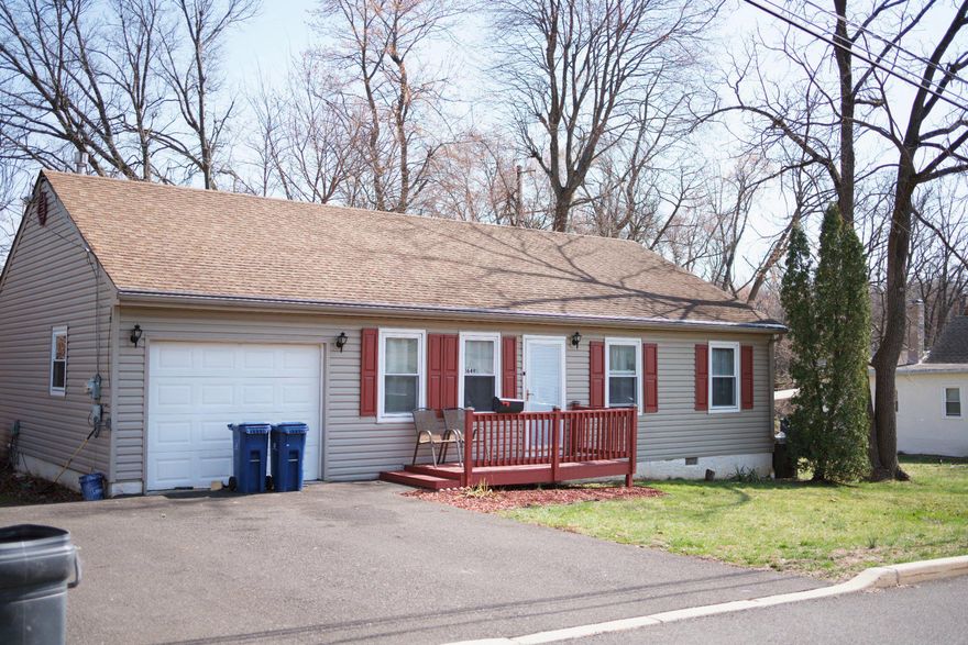 This charming ranch-style home in the Crestmont community offers a perfect blend of comfort and convenience. With 1,152 sq. ft. and additional adjacent parcel #30-00-70656-00-9 included in sale , this well-maintained residence features three inviting bedrooms and two full bathrooms, including a primary bath with a stall shower and tub. The open floor plan seamlessly connects the eat-in kitchen, equipped with modern appliances like a gas range and dishwasher, to the cozy living spaces adorned with hardwood and carpet flooring. Step outside to enjoy the corner lot with beautifully landscaped front and side yards, perfect for outdoor gatherings on the deck or patio. The attached garage and driveway provide ample parking. Located just a mile from bus and commuter rail stations, this home is ideally situated near local parks, schools, and community amenities, fostering a vibrant neighborhood spirit. Experience the warmth of Crestmont, where friendly neighbors and convenient public services create a welcoming atmosphere for all.