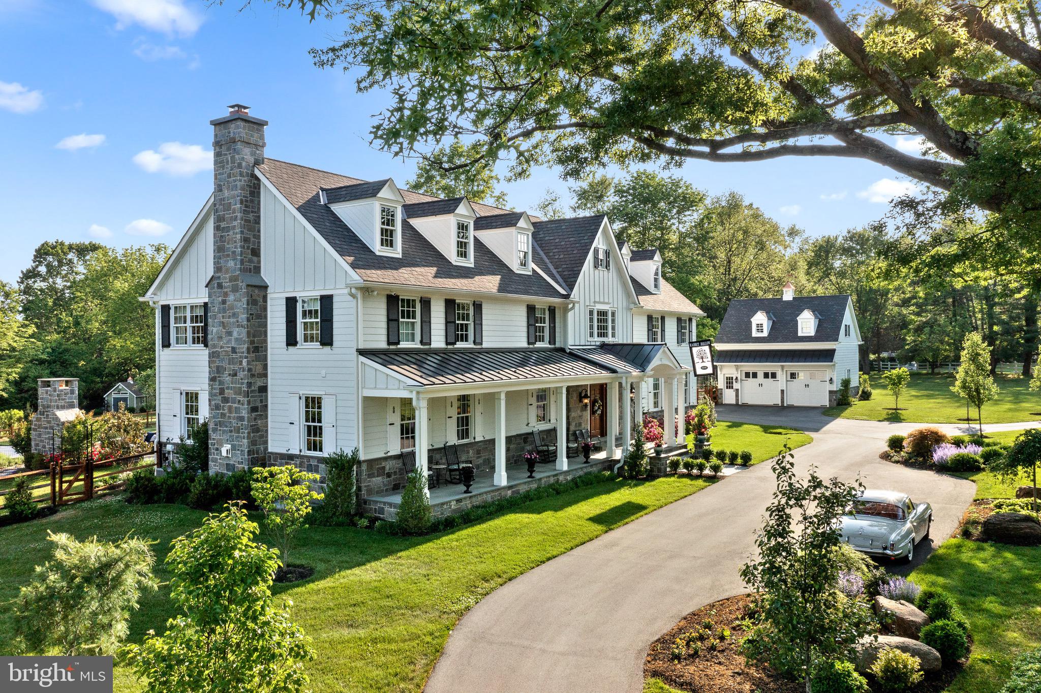 WELCOME to 14 Rabbit Run Road located in one of Willistown Townships most coveted and sought after neighborhoods in the prestigious area of Radnor Hunt. Built in 2018, this turn key, one of a kind residence blends traditional craftsmanship with fine architectural details and incredible design. Follow the tree lined drive to this beautiful home featuring 4 manicured acres with a backdrop boasting of botanical gardens and outdoor resort style living. Upon entering, you will find an open straight through foyer with a grand staircase accented by beautiful herringbone flooring. The home’s interior is designed around an open floor plan suitable for today’s modern family living and entertaining. Formal areas include a living room with coffered ceiling and fireplace, dining room with extensive moldings and coffered ceiling. Family room with fireplace opens to the impressive chef’s kitchen featuring Wolfe & Sub-Zero professional appliances, a large center island with sink, Rohl polished nickel faucets, wine cooler and extensive custom lighted cabinetry. Adjacent to the kitchen is the breakfast room featuring an abundance of natural sunlight, custom made trusses and ship lap style ceiling. The butlers’ pantry situated between the kitchen and dining areas features double drawer dishwashers, beverage center, coffee bar, sink and lighted custom cabinetry. The first floor also includes a large impressive billiard room with cherry wainscoting, cherry custom made bar with hidden pull-out refrigerated drawers, tv and a beautiful fireplace to enjoy while playing a game of pool. Also featured on the first floor is an office, large laundry room, locker and two powder rooms. The second floor includes a superb primary suite featuring built-ins, tray ceiling, fireplace, two custom walk-in closets and two beautiful en-suite tile/marble bathrooms. 2nd floor also features 3 additional bedrooms with custom tiled baths. Additionally, the home has a separate guest suite featuring on site finished hardwood floors, built-in cabinetry with desk area, a large living area with window seat, a full bath and bedroom with carpet, window seat and walk-in closet. For your entertainment, the lower level features a stadium style state of the art movie theater, complete with motorized seating, acoustic sound proofing and accent lighting. Adjacent to the theater is a wet bar with beverage center, sink and seating with a half bath in close proximity. The property also includes an in ground pool with oversized spa, multiple flagstone patios, outdoor stone fireplace, dining area with shaded pergola and a built-in gas grill located just steps away from the kitchen. There is room for a total of 4 cars, 2 in attached garage and 2 in the detached garage with storage area above. Much of the home is controlled by various apps including swimming pool functions, HVAC controls, lighting, irrigation system and security system with several outdoor cameras. Also, a central vacuum system and an emergency stand by generator are just a few more of the amenities that this incredible home has to offer. Just a short ride will take you to many of the areas top private schools, The Radnor Hunt Club and three major country clubs. You won’t want to miss this incredible opportunity as there is presently nothing like this home on the market!! 14 Rabbit Run Road is move-in ready and the perfect place to call home!