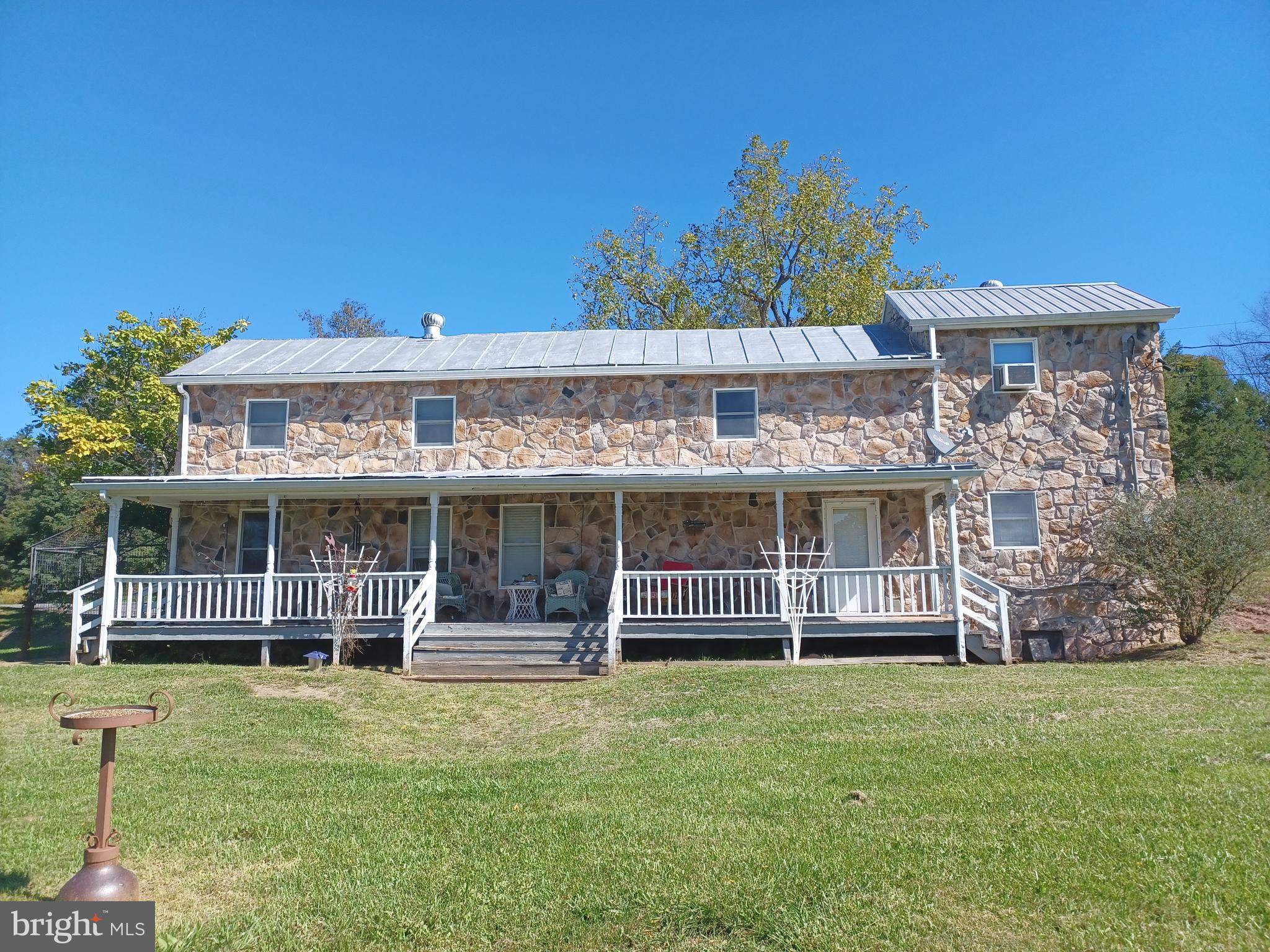 Here is your chance to own 8.39 unrestricted acres in Beautiful Historic Three Churches, Romney WV. Wild and Wonderful at its finest, while a short commute to Northern VA. You can watch wildlife from every window of this original 1830s log cabin all stone home. Deer, Ducks, Bears, Birds, Rabbits, you name it and you will see it here. There is rafting, boating, fishing, camping, hunting as well! This property boast 2 homes, the main homestead has 4 bedrooms and 2 full baths with original wood in the living room and a wood stove. A detached oversized 3 bay garage has a 3 bedroom apartment above. Bring your horses and animals as there are 2 buildings for them and plenty of land to graze, this would make a great Farmette. There is an 33 tree orchard with 4 different types of apples and a pear tree. 2 ponds by the road and one lake that is spring feed and stocked with 5 different types of fish is located in front of the main house with a little pier and a fishing boat that conveys. There is also a creek in the back of the property. Be ready for your piece and quiet at this slice of Heaven.