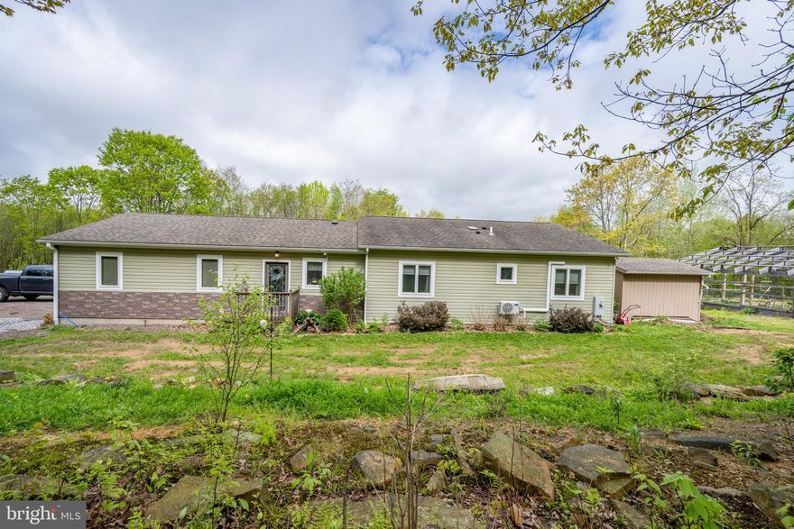 Nestled in the sought-after Highlands community of Grantsville, this beautifully maintained 3-bedroom, 2-bath ranch-style home sits on 10 scenic acres, offering the perfect blend of privacy, comfort, and convenience. Just minutes from Interstate 68 and less than 30 minutes to both Deep Creek Lake/Wisp Resort and Cumberland, the location is ideal for those who enjoy outdoor recreation and easy access to town amenities.

The home features a spacious and inviting layout, highlighted by an open-concept living area and a large kitchen with Corian countertops, an island, and a stylish tile backsplash—perfect for both everyday living and entertaining. All three bedrooms are generously sized and include walk-in closets, while the primary suite boasts a tiled stand-up shower and plenty of storage. Radiant floor heating keeps the home cozy during the winter months, and two ductless mini-splits provide efficient air conditioning and an additional heat source.

Outdoor living is equally impressive, with a covered rear deck that offers a peaceful retreat, complete with space for a hot tub. The backyard is fenced, ideal for pets or kids, and includes a handy storage shed. For those needing extra space for hobbies, storage, or business, the property features a massive 32x45 detached metal pole building garage, in addition to the attached two-car garage. There's also a framed 30x20 post-and-beam structure currently used for raised plant beds, which could easily be sided and finished into an additional garage, workshop, or studio.

Whether you're looking for a full-time residence or a weekend escape, this property combines modern comfort, functional space, and the tranquility of country living—ready for you to call home.