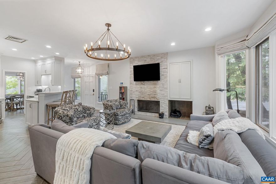 Welcome to this incredibly renovated and upgraded 4 level townhouse in Trillium Close. No stone has been left unturned - high end finishes abound! Enter the main floor where this entire level has heated floors. Cozy living room with wood burning fireplace and gorgeous surround - with firewood included by the HOA! - that flows nicely to wooded back deck facing a golf hole. High end kitchen with fantastic cabinet space and full height quartz backsplash. The second level has a huge primary bedroom with walk-in closet and upgraded bathroom plus secondary bedroom, hall bath, and two linen closets. The top floor continues with two more nice size bedrooms with a bath between. The lower level comprises of an entertainment room with its own mini split plus a mud room to store the golf clubs and skis. Large two car garage with professionally epoxied floors has great storage and opens to a parking pad for two more cars. Fantastic mountain location in close proximity to the Devils Knob Complex with spa, aquatics, fitness, and restaurants. Easy drive out of Wintergreen to the 151 brewery and winery trail!