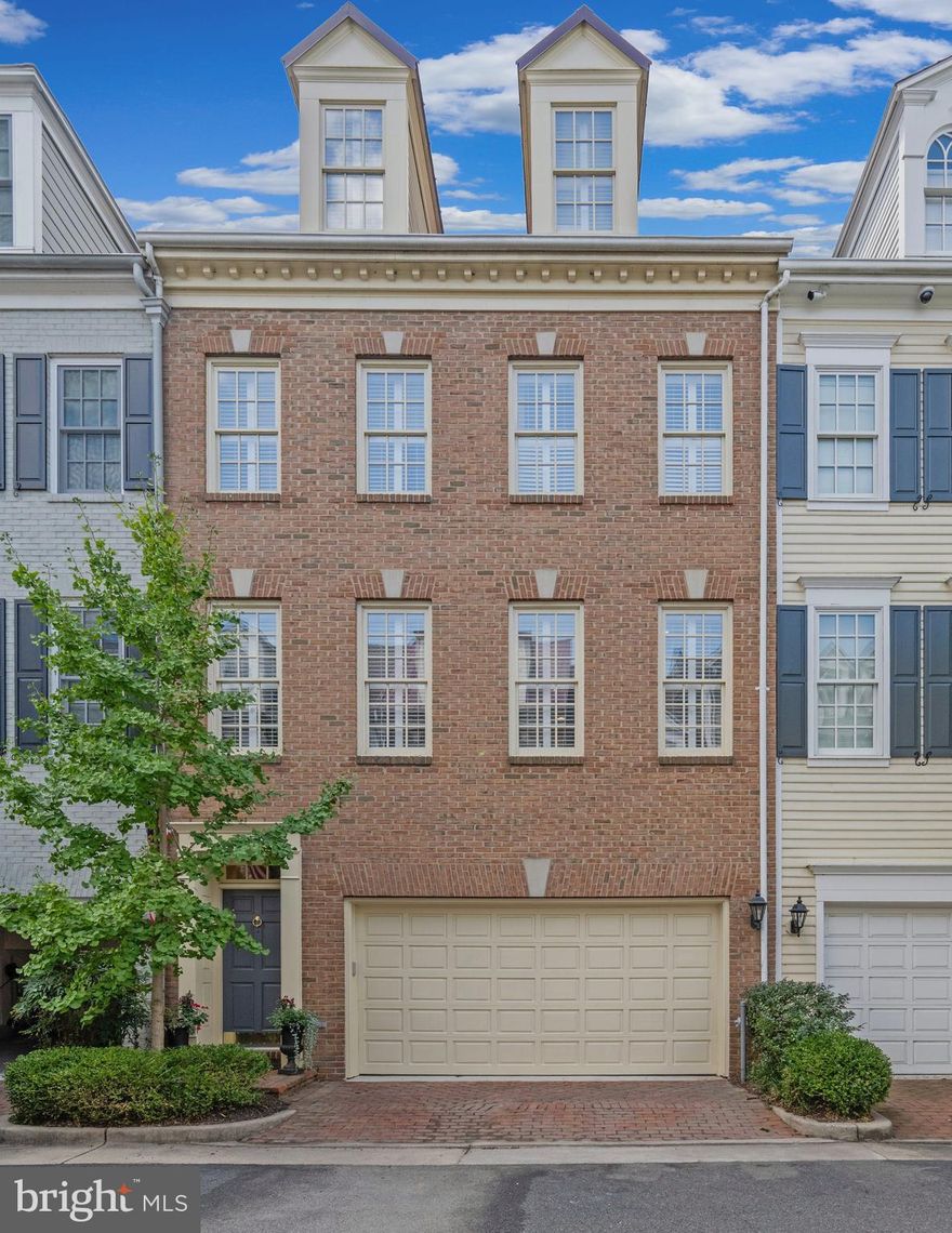 This gorgeous Fords Landing townhouse is just steps to the river and overlooks a magical setting of trees and parkland from 3 outdoor areas including two balconies and a brick patio.  The all-brick 4 level property spanning 3330 sq ft. offers 4 bedrooms, 3.5 baths and is one of the largest models in this sought-after peaceful and manicured waterfront community located just 6 blocks from the restaurants and shops of King St.  This light filled home offers a re-designed open concept layout on the main level with the living, dining and family room area centered around a true chef’s kitchen featuring a wrap- around Calacatta marble breakfast bar that can seat 10.  Access to one of the balconies adjacent to the kitchen allows for easy and convenient grilling.  On the lower level, the brick patio is accessed via a cozy recreation room that impresses with modern alpine design elements of natural stone flooring, rich wood finishes and deep earthy color palettes.  Upstairs, the primary suite is a luxurious, tranquil retreat with a sitting area leading to the third outdoor area – a balcony overlooking a beautiful natural scene that affords winter views of the river. The suite features a gas fireplace, tray ceiling, remote controlled window blinds, two fitted walk-in closets and a primary bathroom with a double sink marble vanity and jacuzzi tub.  The second bedroom is currently used as an office and is fitted out with Elfa shelving that was previously used entirely as closet space for the adjoining primary bedroom.   A spacious third bedroom on the upper level, with en suite bath and soaring cathedral ceilings, affords privacy and independence to visiting guests while the fourth bedroom, currently used as a gym and yoga room, is fitted with a murphy bed for those extra guests. The property has been meticulously maintained and renovated with designer touches throughout.  Other features include 9’ ceilings and hardwood floors on main levels, plantation shutters, extensive kitchen cabinetry, Jenn Air appliances including a double wall convection oven and gas cooktop, a built-in coffee cabinet, 3 contemporary linear gas fireplaces, wet bar and cabinetry in family area, laundry closet on bedroom level and extensive storage throughout including two large interior storage rooms.  Completing this lovely home is a 2-car garage with a newly painted epoxy flake flooring , fitted cupboards and an additional storage area.