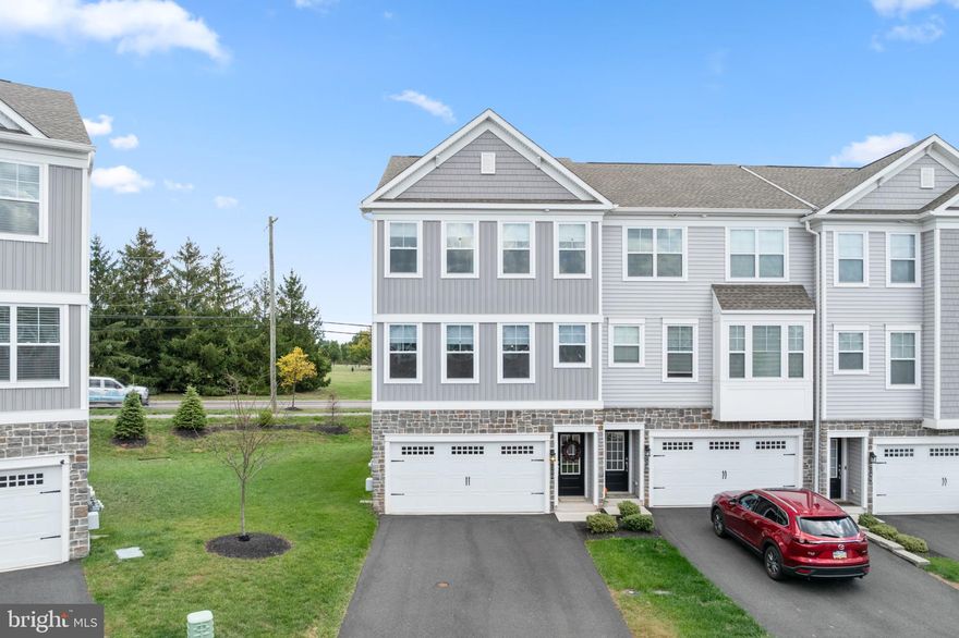 Welcome to this gorgeous, nearly new multi-level end-unit townhome built in 2021! Contemporary design and a thoughtful layout create a warm and inviting atmosphere throughout. Upon entry, you’ll appreciate the elegant oak staircase with American Craftsman posts and white square balusters leading to the main living area.

The bright and airy open-concept floor plan flows seamlessly through the living room, dining area, kitchen, and sunroom — perfect for both everyday living and entertaining. The home features beautiful engineered oak hardwood flooring throughout the main level, complemented by warm, neutral tones.

The inviting living area includes a stylish dry bar with custom cabinetry, a beverage fridge, and open shelving — ideal for entertaining. The kitchen is a chef’s delight, showcasing 42" maple cabinetry with crown molding, quartz countertops, a classic farmhouse sink, and an impressive 8-foot island with seating, perfect for casual dining or gathering with friends and family.

Just off the kitchen is a spacious dining area for family meals and get-togethers. From there, step into the inviting sunroom — an ideal spot for morning coffee or relaxing with a good book. A large 8-foot sliding door opens to the 12' x 10' Trex deck, which overlooks scenic Limerick Community Park. The community also offers a convenient crosswalk leading directly to the 70-acre park, featuring walking trails and a variety of recreational amenities, including bocce courts, basketball courts, playgrounds, and more.

Moving to the second floor, the primary bedroom impresses with its cathedral ceiling, walk-in closet, and luxurious en suite bath. The en suite features a double-bowl vanity with upgraded countertops, ceramic tile flooring, and a spacious shower with ceiling-height subway tile and a built-in bench for seating. Two additional generously sized bedrooms, a full hall bath, and a convenient second-floor laundry room complete this level.

Finishing on the lower level, this area offers a versatile space that can be used as a family room, home office, gym, or playroom. Sliding doors open to the ground-level concrete patio, providing a great spot to relax outdoors. The attached two-car garage adds both comfort and convenience, featuring built-in overhead storage for optimal organization.

For year-round comfort, the home includes a whole-house humidifier and water softener.

Located within the highly acclaimed Spring-Ford School District, this home is centrally positioned with easy access to Route 422 and other major roadways. Enjoy being just 20 minutes from King of Prussia’s premier shopping and dining destinations, and within walking distance to Limerick Community Park for even more outdoor convenience.