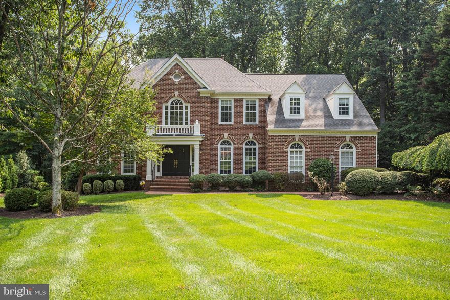 This magnificent brick colonial located in desirable Timberlake Estates South offers over 4,800sf of beautiful living spaces within a private neighborhood setting and park-like views.  With 4 Bedrooms, 4.5 Bathrooms and designer touches throughout, you will love living here!  Delight in the magnificent gourmet Kitchen with a large center island, natural quartzite stone counters, high end stainless steel appliances, and gorgeous windows overlooking the backyard.  The Breakfast area has direct access to the expansive rear deck ideal for relaxing, grilling, and entertaining.  The open and light filled Family Room features high ceilings, a floor-to-ceiling stone gas burning Fireplace, skylights and oversized windows.  The main level also offers hardwood floors, the organized and inviting Laundry Room, the must-have private home Office, a large Dining Room with bay window and wainscotting detail, and open Living Room with floor-to-ceiling windows.  Retreat to the tranquil and spa-like Primary Bedroom Suite with luxurious marble tile Bathroom offering an oversized soaking tub, separate glass-enclosed shower, and two-sink designer vanity.  An additional 3 Bedrooms, one with ensuite Bathroom and two others with Hall Bathroom, complete the well appointed upper level.  The walk-out lower level has a large Rec Room area that opens directly to the backyard, a Full Bathroom, and Movie Room.  Main-level 3-car Garage, expansive rear deck, patio space beneath the deck and wooded backyard views make for a spectacular setting in Great Falls, the DC area’s premier suburb.  A whole house Generac 22KW generator is also installed.  10 minutes to Reston, 15 minutes to Tysons, 20 minutes to Dulles International Airport. Enjoy all that the Great Falls community has to offer - the Village center, Great Falls National Park, Nike Park, Turner Park, River Bend Park, the library, and top rated schools in the Langley pyramid.