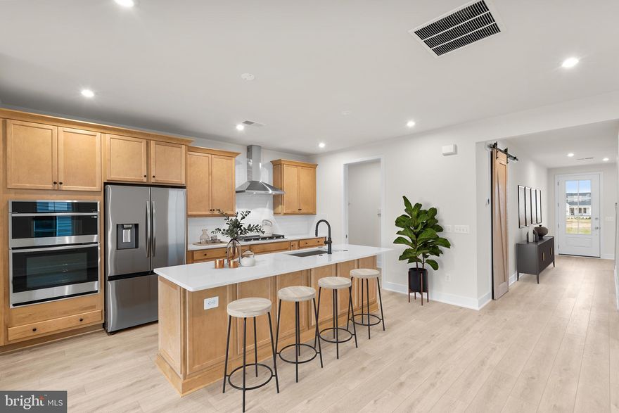 Embrace the Vera 30-F2 – Homesite 1094 at Hiatt Pointe in Winchester by Van Metre Homes—a two-car, front-load garage END VILLA HOME with three bedrooms, two full bathrooms, and one half bathroom ready for you to move in IMMEDIATELY. Built for the way you live, this factory-framed floorplan makes room for moments big and small with its natural flow. Be welcomed by 9’ ceilings on both levels, luxury vinyl plank (LVP) flooring, oak main stairs, and expertly selected finishes that make this villa feel effortlessly unique. The kitchen, central to the entire home, is complete with cabinetry, quartz countertops, an island with a built-in trash can, Samsung® stainless steel appliances, and a pantry with solid shelving off the mud room. The great room features electric fireplace that adds a cozy focal point and a spacious 21’ x 8’ patio. The main level primary suite includes a spa-inspired bathroom with dual vanities, close cabinets, quartz countertops, a roll-in frameless shower with white floor-to-ceiling tile, and elongated comfort-height toilets. Upstairs, enjoy a flexible retreat, two secondary bedrooms, and a full bathroom. The two-car finished garage with electric opener and exterior keypad adds extra storage and convenience. Built for comfort and sustainability, this home features smart home technology and energy-saving innovations, including a Home Automation Package, smart programmable thermostat, and more. Plus, it’s solar panel ready! Being a new build, your home is constructed to the highest energy efficiency standards, comes with a post-settlement warranty, and has never been lived in before! Take advantage of closing cost assistance by choosing Intercoastal Mortgage and Walker Title.------Discover Hiatt Pointe at Snowden Bridge, a gated active adult community designed for 55+ living, where every day brings new opportunities to connect, unwind, and thrive. Start your morning with a yoga session or workout in the fitness center before joining friends for a game of pickleball or billiards. In the afternoon, lounge by the outdoor pool and hot tub, then gather around the gas fire table as the sun sets. The clubhouse serves as the heart of the community, offering inviting spaces for social events, group activities, and quiet relaxation. Outdoor kitchens and scenic patio areas set the stage for effortless entertaining, while a low-maintenance lifestyle ensures more time for what matters most. With easy access to Route 7, I-81, and I-66, Hiatt Pointe offers the perfect blend of resort-style amenities and a welcoming, connected community.---- *Other homes sites and delivery dates may be available. Pricing, offers, and availability are subject to change without notice. Images, renderings, and site plans are for illustrative purposes only and may not reflect actual homes or features. Additional terms and conditions may apply. Please see a Van Metre Sales Advisor for details.