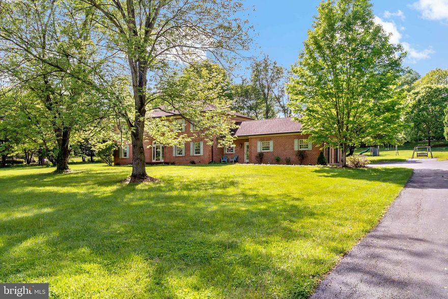 Welcome home to this beautifully crafted 4-bedroom, 2.5-bath all-brick Colonial nestled on 2.48 meticulously landscaped acres. This home is filled with quality and thoughtful design—from real oak trim and solid hardwood flooring to a custom kitchen, elegant crown moldings, and custom double-lined draperies. Multiple living areas, cozy fireplaces, and natural light from skylights create an inviting, functional layout for everyday living and entertaining. Step outside and explore the expansive backyard with mature natural edging—trees, shrubs, and hedges valued at over $20,000—offering exceptional privacy across the full 2.5 acres. A second fire pit and charming area tucked near the shed make the perfect campsite or outdoor play space for kids. Additional highlights include an owned (not leased) propane tank, newly insulated garage doors, fresh brickwork on the front porch, and new carpet in the partially finished basement. A golf cart is included for easy access to community amenities like deep-water Potomac River access with boat ramp, pools, courts, and more—ideal for kayaking, jet skiing, or fishing. Located just minutes from Spring Mills shopping, dining, and I-81, this home offers both tranquility and convenience. Come experience the quality and comfort for yourself!