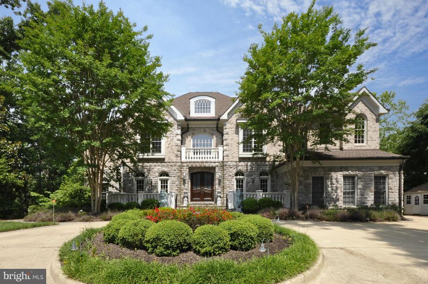 Huge Price Reduction!!! Stunning stone custom colonial perched high on a hill overlooking wooded lot w/ infinity pool, patio, built-in bar & barbecue. Great floor plan features sun-filled two story family room, paneled library, chef's kitchen & hardwood floors throughout. Wonderful lower level w/ full-size bar, home theater, gym, au-pair suite, billiards area & walk-out to backyard. 4-car garage.