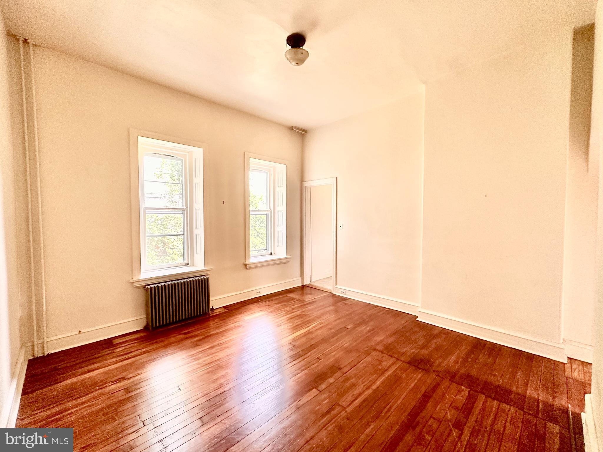 Stunning one bedroom Germantown first floor apartment in beautiful building. HIGH ceilings and wonderful natural light. Hardwood floors throughout. Private rear porch and garden area. Well-equipped eat-in kitchen. HUGE living room and bedroom with deep window sills. Shared coin-op laundry in basement. Shared off-street parking available (first-come, first-served). Great gigantic front porch is shared with the building tenants. Plenty of outdoor space for everyone. Cat friendly, dogs considered - no added pet fees. Tenants pay gas and electric. First, last and one month security due at lease signing. Strong credit over 650 and verifiable income required. Inquire for the video tour, showings, and applications. Available immediately.