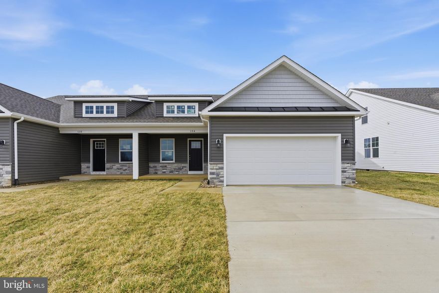 Immediate delivery on this beautifully designed 2 bedroom, 2 bath Villa design offering 1527 finished sqft.  Step inside the large Family Room equipped with vaulted ceilings, recessed lighting and ceiling fan, and luxury vinyl plank flooring.  The kitchen is deigned with large island w pendant lighting, granite countertops, coffee bar, a large pantry, and stainless steel appliances.  The 19ft Primary Bedroom offers 2 walk in closets, recessed lighting and ceiling ceiling fan, built in USB ports, Hi-Lo pre-wired cable outlets set up for hanging tvs, and plenty of natural light.  The primary bath has dual sinks with granite tops, built in storage in cabinets, and barn door separating the tile shower with bench seat and glass door.  The home comes with 2 car insulated garage w auto opener, front porch and stone accents, concrete driveway and rear concrete patio. Conveniently located near I-81, Hedgesville, and Spring Mills—with shopping, dining, and everyday essentials just minutes away