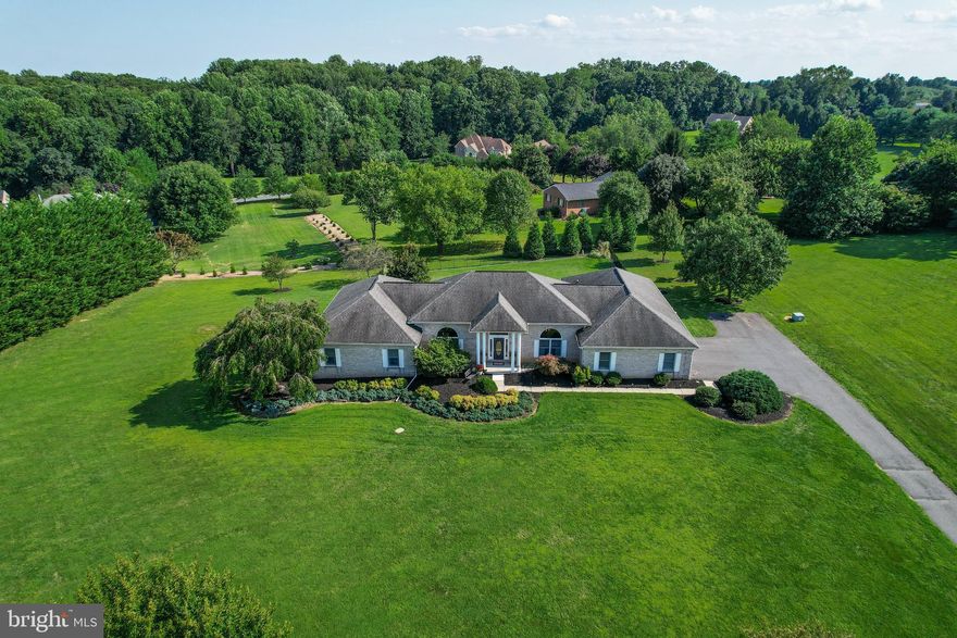 Welcome to this sprawling rancher situated on a large lot in the popular neighborhood of Hunt Field.  From the moment you enter the front door,  you will be wowed by the open foyer and soaring 12 ft. ceilings.  Fluted columns frame the entrance to the formal dining room while  elegant moldings and a large arched window set the stage for your holiday gatherings.  The formal living room boasts the same arched window allowing for an  abundance of natural light.  As you follow through the foyer, you will enter the heart of the home. The open floor plan combines the kitchen with granite countertops, an island and stainless steel appliances, a breakfast area and the family room with gas fireplace.  Both the family room and breakfast area offer access to the large patio overlooking the fenced rear yard perfect for relaxing with the family or entertaining! Three of the bedrooms are located down the hall from the family room while the 4th bedroom is currently used as a home office.  The laundry room and 2nd pantry are also located down the hall from the kitchen.   Additional features included 2 new furnaces, a tankless water heater, 3-car garage and an enormous unfinished basement.  This gorgeous home is truly a must see!  Schedule your private tour today!