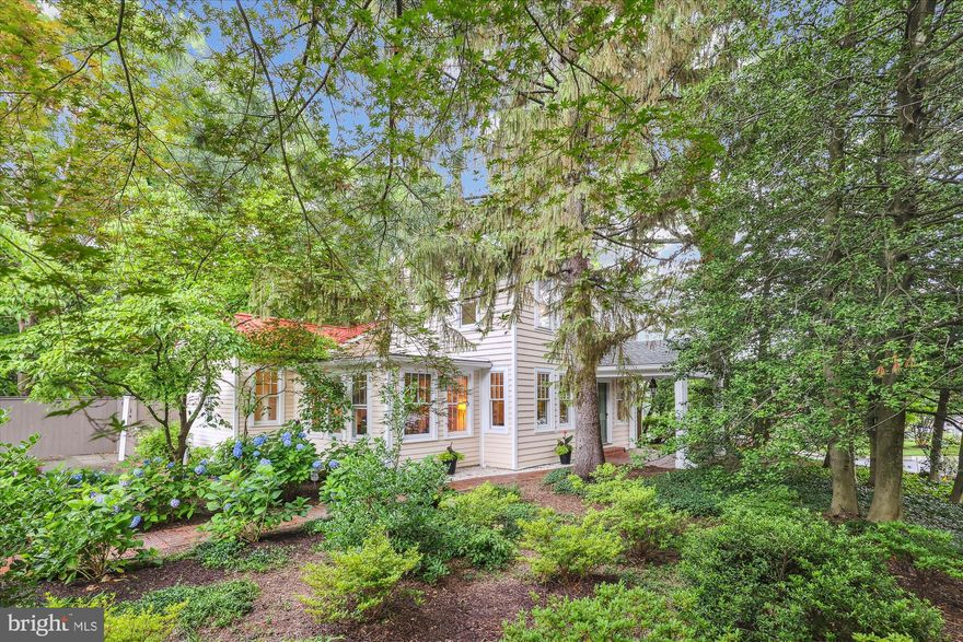 Don’t miss this beautiful and rare historic gem nestled in the heart of Falls Church City, with excellent walkability to shops, restaurants, Whole Foods and East Falls Church Metro!  This exquisite 3BR/2.5 BA farmhouse on 3 levels (plus finished ADU in rear) features excellent light and flow and is the perfect blend of historic charm and character, with all the modern comforts for today’s lifestyle.  Set on a private, picturesque and landscaped lot, the inviting covered front patio with adjoining brick paths leads to the home’s welcoming front door. Step into the light-filled foyer with gleaming hardwoods floors (that run throughout) and you’ll notice the fine architectural craftsmanship as you walk through the home.  The expansive and elegant living room includes light-filled windows plus fireplace with mantel.  The thoughtful, gourmet chef’s kitchen is a complete dream with vaulted ceiling, large island with lots of workspace, plus a 6-burner Viking gas range and dual ovens, KitchenAid refrigerator/freezer, new Bosch dishwasher (2025), granite counters, custom tile backsplash, cherry cabinets and 2 stainless, extra deep sinks.  Plus, there is a lovely breakfast area off the kitchen with walkout to the oversized patio and a conveniently located mud room.  The large, formal dining room off the kitchen includes built-ins and crown molding; the adjacent light-filled sunroom/office provides the perfect peaceful retreat or workspace, and a lovely half bath completes the level.  Upstairs includes the large primary bedroom with built-in closets, lots of windows and sparkling hardwood floors. This level features 2 generously sized additional bedrooms and 2 full bathrooms.  Downstairs is loaded with space and storage, utility and laundry rooms, plus a big workshop.  Enjoy your private oasis with the in-ground lap pool, patio spaces, outbuilding/shed and versatile ADU with full bathroom, sink and counterspace for small kitchenette!  All in a super Falls Church City location and Falls Church City Schools!