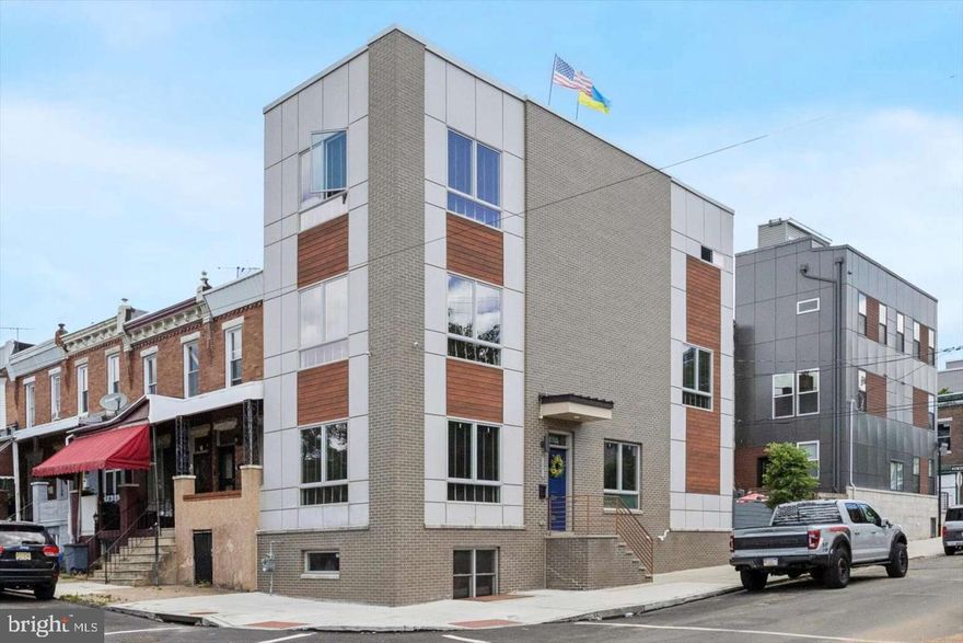 Modern, comfortable living in the highly sought-after Brewerytown neighborhood! This sunny home has five bedrooms, four full baths, two half baths, a finished basement, a yard, a rooftop deck, lovely wood flooring, 2 zoned HVAC, and more! The spacious living and dining room has three exposures, large windows, high ceilings, and built-in speakers. The kitchen has white cabinetry, quartz countertops, a backsplash, stainless steel appliances, a bar counter, and an island. There's a pantry closet, a half bath, and French doors leading to a large private patio for outdoor dining and entertaining. The second floor boasts two bright bedrooms with large windows and double closets. There's also a laundry/storage closet with an oversized washer and gas dryer, a linen closet, and a full tile bath with a stall shower. The third floor is home to the main bedroom suite with tall ceilings, two exposures, 2 walk-in closets with built-ins, and a spacious all-tile bath featuring an oversized tile shower, dual contemporary vanity, and watershed. This floor also has a half bath for guests with access to the rooftop deck, including a hot tub, outdoor sectional, and gas fire pit, offering stunning 360-degree skyline and open sky views. The finished basement can serve as a den, office, or family room, with carpeting, windows, a full bath, and a storage closet. The rear has an additional bedroom with carpeting, a double closet with built-ins, and a full-size well. There is great value in this vibrant area - don't miss out!