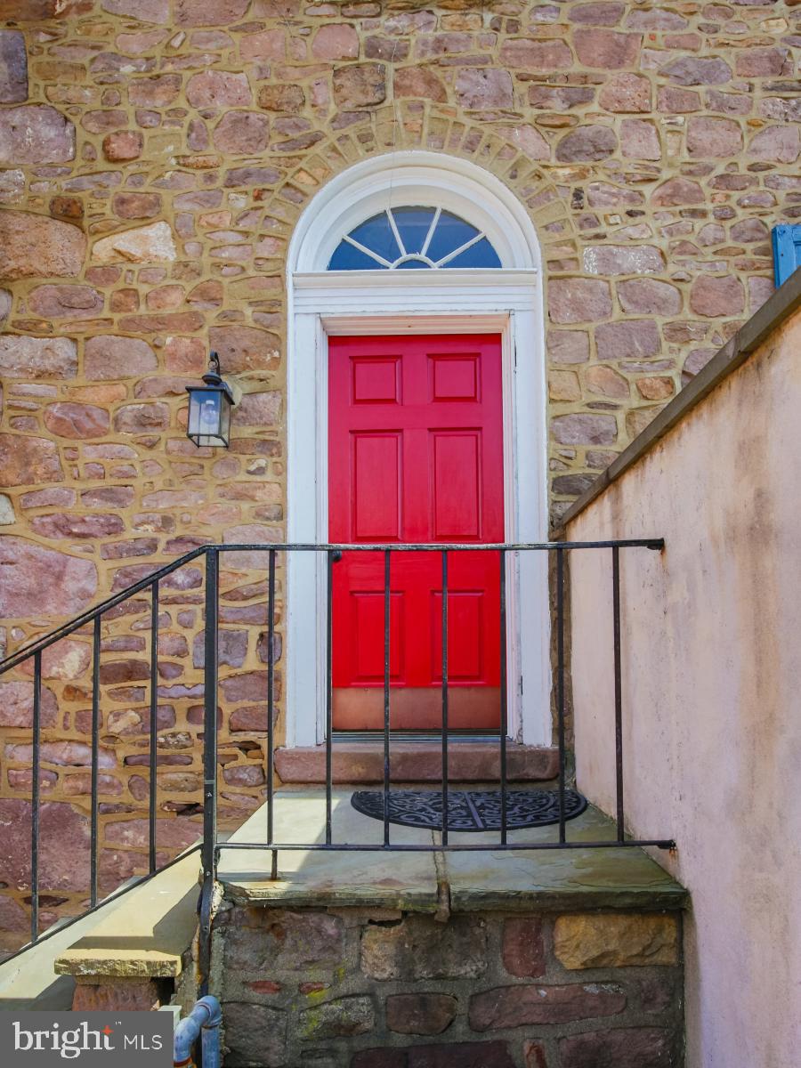 In the center of the borough, close to Starbucks and surrounded by trendy restaurants, pubs and boutiques, this is the location that could be yours. Behind the stunning red door you will be entering a custom-molded, brick-floored, and crystal-lit entryway. The unit has been completely renovated. Gleaming ,refinished hardwood flooring is found throughout the apartment. The living room is generously sized with antique French doors leading into the dining room complete with a crystal chandelier. The cook's kitchen includes stainless steel appliances, gas range with built in microwave, sink disposal system, granite counter tops and wood-grained ceramic flooring. The custom wood cabinets have under-cabinet lighting, pantry and chef's spice closet. The kitchen has its own private entrance/exit that opens onto the building's private green space. Green Space Features 1/2 Acre Private Park, like Yard That is Exclusive to Our Residents! One of The Only Properties in Newtown Borough That Offers Such Private Space with the Best Views of Parades and Community Events! Enjoy This View Right From Your Doorstep! The bedroom includes an ensuite bathroom which has marble and ceramic tile with a pedestal sink, oversized custom shower, toilet and Kohler fixtures. An efficient electric hydronic heating system allows you to adjust the temperature in each room. The unit offers generous storage spaces and a full sized stackable washer and dryer, and comes with a convenient municipal parking pass. 35 South State street is a historic building that dates from 1726.