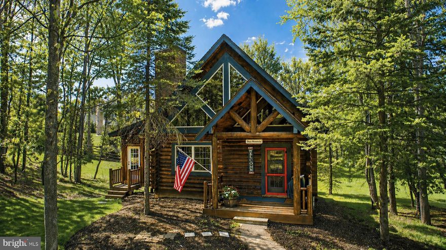 Tucked in the Yellowstone Village community at Deep Creek Lake, “Dan’s Mountain” is a charming log cabin retreat offering the perfect blend of mountain serenity and convenient access to the area’s top attractions. This 3-bedroom, 3-bathroom home comfortably accommodates guests spanning over 3 levels with a bonus enlcosed porch area. Warm wood interiors and a classic cabin feel welcome you inside, where multiple gathering spaces—including a cozy living area and lower-level den—provide room to relax and unwind. A standout feature is the enclosed sunroom with an indoor hot tub and stone fireplace, offering year-round enjoyment in a private setting. Outdoor living is just as inviting, with a spacious yard perfect for entertaining after a day at the lake. Located just minutes from Deep Creek’s most desirable amenities, this home brings you four seasons of enjoyment. Additionally, Yellowstone Village is one of Deep Creek Lakes top producing cabin rental communities.
