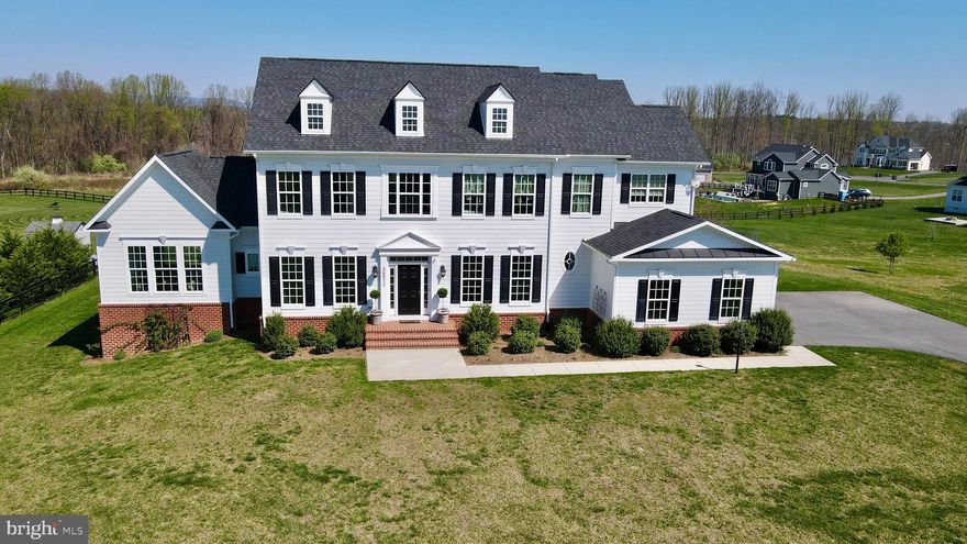 Set within the Hunt Ridge Preserve community of Purcellville, 36972 Bridle Ridge Lane unfolds across nearly two acres, where open space stretches behind the home and a distant tree line frames the setting without closing it in. That same sense of scale carries through the home itself, with four bedrooms, three full and two half baths, and over 6,000 square feet of total space across three levels, shaping a layout that moves comfortably from one space to the next.

From the moment you arrive, the depth of the homesite and the distant tree line come into view. Inside, a two-story foyer opens into a central hall, where the transition into the main living spaces is defined by a series of keystone-trimmed arches, giving a clear sense of structure as you move through. The formal dining room carries four-piece dentil molding, adding detail and finish without overwhelming the space, while a private office with French doors sits just off to the side.

Further in, the home opens into the spaces that carry everyday living. The family room, centered around a fireplace and framed by a coffered ceiling, connects seamlessly to the kitchen, where the scale and layout are immediately apparent. A generous center island fitted with dual dishwashers anchors the space, creating a natural gathering point, while the butler’s pantry and separate walk-in pantry keep prep and storage tucked just out of view. Just beyond, the club room draws in natural light throughout the day, with vaulted ceilings, a second fireplace, and views that extend across the rear of the property and surrounding landscape.

Upstairs, the primary suite is set apart with the scale and layout to function as a true retreat, where windows take in the surrounding landscape and frame views toward Short Hill Mountain. The space is complemented by dual walk-in closets and a well-appointed bath with a soaking tub, separate shower, and dual vanities. The secondary bedrooms are laid out with a balance of privacy and connection—one with its own en-suite, and two joined by a Jack & Jill bath.

The walk-out lower level, already roughed-in for a full bath, offers a clear opportunity to expand—whether for additional living space, a guest suite, or a recreation area that evolves with your needs.

Outside, the property continues to unfold. The nearly two-acre homesite is both open and framed, with the rear of the property extending toward a tree line including Berry and Fruit trees serving as your own orchard! The raised garden beds and established plantings introduce structure and seasonality to the landscape without taking away from the openness of the lot.

Hunt Ridge Preserve offers a quieter, more tucked-away setting while still keeping you close to everything that defines western Loudoun. Just minutes from the center of Purcellville, you’re surrounded by local restaurants, coffee shops, farm markets, breweries, and wineries, along with everyday conveniences right nearby. Outdoor recreation is woven into the area, with access to the W&OD Trail, Franklin Park, and the Blue Ridge foothills just beyond.

Located just minutes from the heart of Purcellville, with access to Route 7 for commuting toward Leesburg, Ashburn, and beyond, the home offers a balance of space, setting, and convenience.