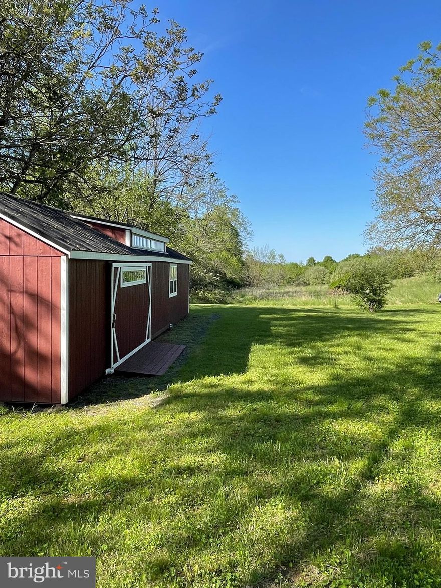 This beautiful homesite is private and secluded yet minutes to the charming town of Berryville.   This 3 acre lot is unique in that it would be a easy build with flat lot with a 4 bedroom perc site that really has it all.  Just a few miles from the river, public boat land and all that the town of Berryville has to offer including restaurants, shopping, farmers market and many local activities.   This lot has a well installed and septic documentation.  Lot also includes a 40 X12 outbuilding ready for immediate use.   Neighborhoods nearby but you are set on a private lane with three homesites.  Build the home on your dream in this great location and enjoy the private lifestyle with  the mountain views.