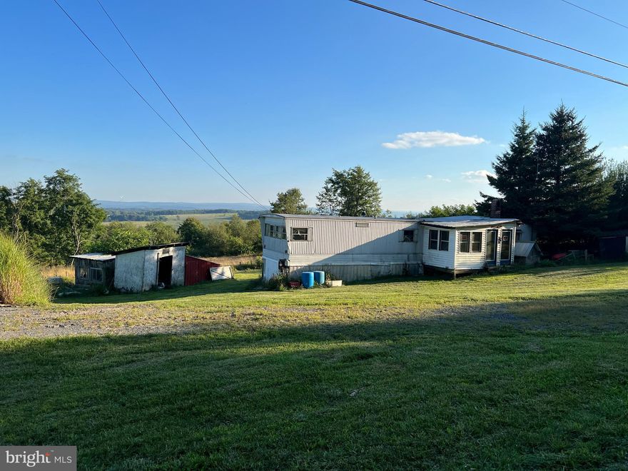 This half-acre property, just minutes from town, is a canvas awaiting your personal touch. Key features include: Multiple Outbuildings, Concrete Pad (Ideal for your travel trailer or future garage), and a Fixer Upper Trailer perfect for someone willing to put in some DIY and time. Enjoy the beautiful view and privacy this land has to offer, all while being minutes away from town. Affordable property doesn't come on the Market often, so don't wait to contact me today to schedule a showing!