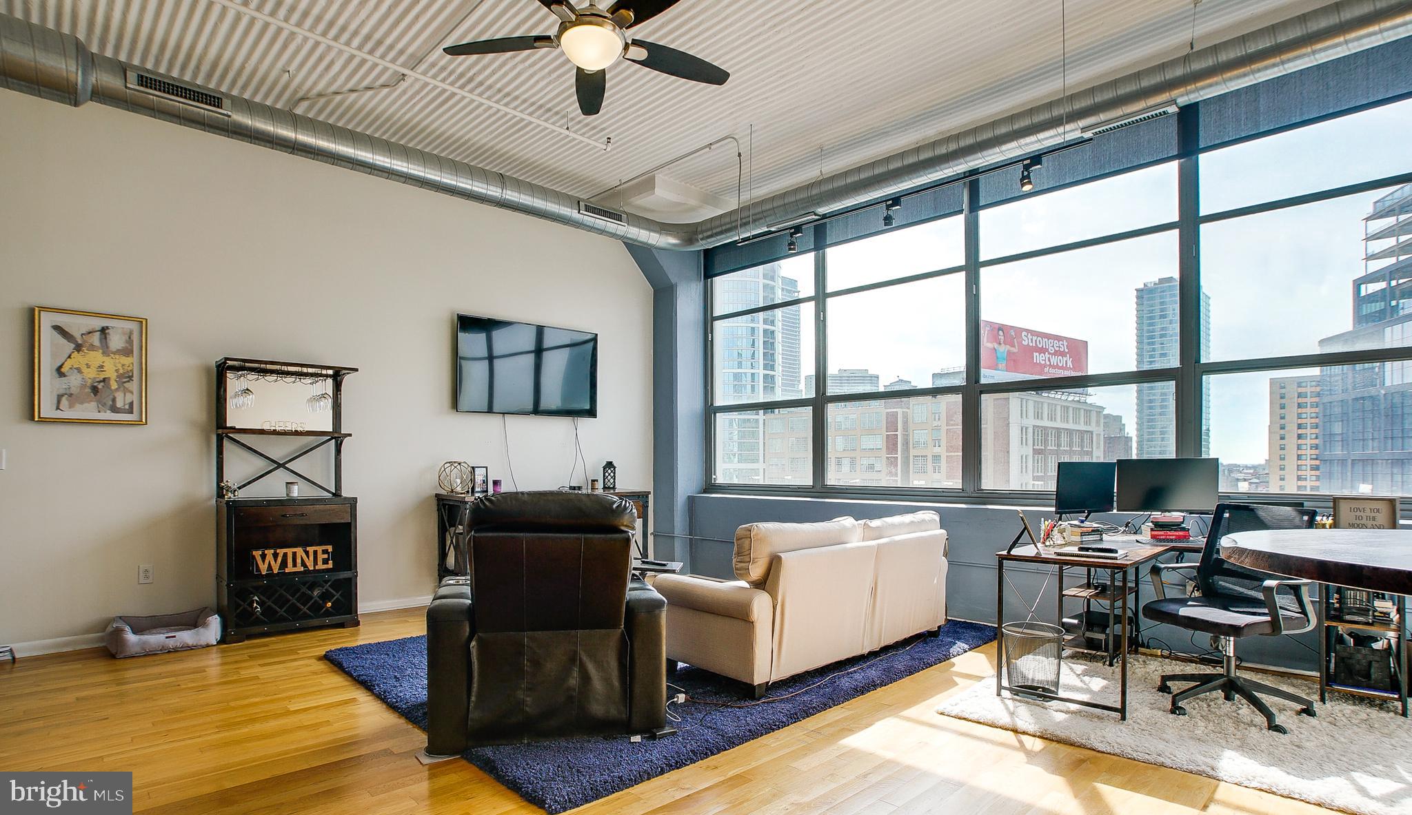 Located in Logan Square, 2200 Arch St is an award winning New York style loft building with 24 hour doorman, fitness center and is pet friendly. This expansive 1 bedroom/ 1 bathroom condominium, with covered garage parking, has unobstructed city views. The oversized windows face south so there is always an abundance of natural light. The living and dining area have 14 foot ceilings and beautiful hardwood flooring. This condo is set apart from other 1 BR's as it has a spacious private bedroom with transom windows that allow natural light into the room. The kitchen has stainless steel appliances, an abundance of cabinet space and granite countertops. The generously sized bathroom has a utility closet which includes a full sized washer/dryer, the hot water heater and storage. 2200 Arch enjoys incredible location and is steps away from Rittenhouse Square, Trader Joe's. Flagship Giant, the Schuylkill trail, 30th St Station and University City.