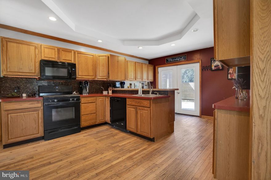 If something unique is what you have been looking for....look no further!! This huge colonial style home is unlike anything in the area- farmhouse vibes with oversized rooms and tall ceilings! 
Driveway is on the side of the home- enter through the side door with a bright entry way/mud room area. New laminate flooring & plenty of space to have a bright reading nook, or create a creative cubby space for all of the things. Next you will find your huge kitchen with lots of cabinets, and great counter space!! No shortage on storage here!! Breakfast bar with cabinets underneath, serving area, desk area, gas stove, deep sink with detachable faucet, French doors leading to deck & backyard oasis. Off of the kitchen is a large walk in pantry/ laundry room with cabinets & another space (unfinished) where an extra bathroom could be! Plumbing is exposed making this project an easy one to complete!! The open kitchen leads you to your super spacious, living room & dining room with plenty of natural lighting, high ceilings, dual ceiling fans/lights, recessed lighting, stone slate tile flooring, crown molding, marble windowsills, electric fireplace under chunky wood mantle. Front door entryway has marble flooring. 
Upstairs you will find 3 generously sized bedrooms. Bed #1 offers new drywall & fresh paint, recessed lighting, ceiling fan/light & updated laminate flooring. Bed #2 offers a deep closet, laminate flooring, a tasteful fan, recessed lighting on dimmers, and an adorable bench nook with storage underneath & a cubby area for storage. Bed #3 offers a walk in closet, light/fan combo & updated laminate flooring. Hall bath with dark vanity & granite counters, laminate floor, small linen closet. In the hall you will find an additional linen closet, and a stairwell to the 3rd floor leading you to a 4th bedroom, loft area or studio! 
Deck built around the above ground pool, Tiki Bar with sink is perfect for summer nights & entertaining family & Friends. Step down to a lower deck, level backyard with a fire pit, shed & gazebo area. 
Pool liner was replaced 2 years ago, 2019 roof was replaced (tear off & replaced plywood, rubber roofing & shingles) Deck replaced & extended in 2025, double gates off of driveway to pull trailers/trucks into backyard if needed,  New electric panel in 2016, HVAC boiler replaced in 2016 or 2017 (Motherboard in HVAC replaced in 2025), water heater 2016 or 2017, Basement bilco doors replaced in 2016.