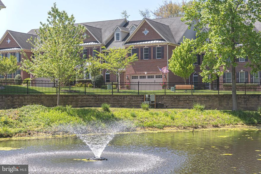 A tucked away, rare find on a superior lot with one of the largest backyard patios and private wooded backdrops in the admired 55+ active adult community of Delancey Court, is this exceptional, custom carriage home with relaxing pond views. Mirroring the architectural design of historic Philadelphia with its brick facade and cobbled drive, this 3 bed, 2.2 bath home offers functionality at luxurious standards along with low maintenance living in a tranquil neighborhood setting. Enter to be impressed instantly by an eye-catching iron baluster staircase, rich walnut hardwood floors guiding you throughout the main level and generously sized spaces all graced with stylish upgrades, detailed woodwork, and ornamental trim/molding at every turn. The chef’s gourmet kitchen with breakfast nook and designer cabinetry, stately column adorned dining area and spacious family room combine to display an openness creating a substantial “great room” concept providing comfort and ease for entertaining. The gathering room has many notable features including a stunning boxed beamed ceiling, floor-to-ceiling stone fireplace, view of the loft above and two stories of windows allowing for an abundance of natural light. Each window in the back of this lovely home offers a picturesque, serene view of the wooded, private backyard. Conveniently, the light-filled breakfast area has direct access through its 3-paned glass slider to the paver patio where the lush rear exterior landscape defines relaxation and tranquility. Completing the main level is a chic styled half bath and a hallway leading to an oversized 2-car garage installed with a Gorilla garage system. Upstairs boasts an open large loft area, one side overlooking the family room and the other overlooking the living room. The striking tray ceiling adorned primary suite offers two large walk-in closets embellished with custom built-ins and lavish main bath. Nothing was sacrificed when designing this NEWLY remodeled sumptuous bath with alluring appointments including radiant heat, stunning tile, a frameless walk-in shower, custom dual sink vanity with marble counters, stylish cabinetry, soaking tub with marble surround and a private commode making this space a soothing retreat all on its own. There are two additional bedrooms on this level sharing a full hall bath and a beneficial laundry room. A third-floor loft provides another gathering space or private respite for guests, currently utilized as a combined home office and sitting room with a neighboring half bath. Other home amenities include stainless steel appliances, transom windows, metal roofing accents, covered front porch and much more! The Delancey Court community offers residents access to enjoy a state-of-the-art clubhouse, fitness center, indoor and outdoor pools, bocce court, conference room, game room and great room with a catering kitchen. The desirable location is convenient for shopping, dining and recreation in nearby Newtown and New Hope and easy access to I-295 making travel to Philadelphia and New York an easy commute. This home is in pristine condition and is truly a statement in quality, luxury, and outstanding design showing like a model. Come make this home crafted for maximum comfort and luxury with minimal maintenance your forever home today!