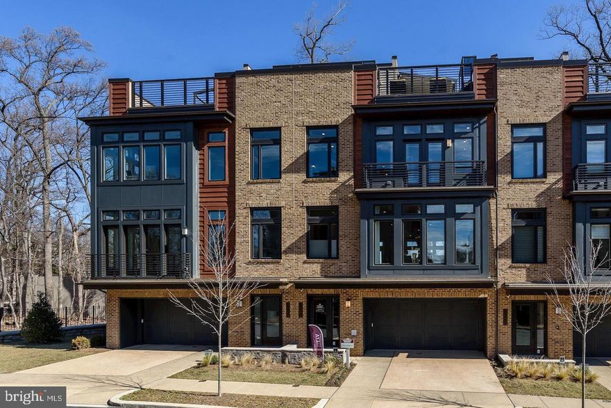 Welcome to Grosvenor Heights — where elevated living is more than just a metaphor.
This is The Harrison, an EYA townhome that hits different. With over 3,500 square feet tucked into a lush, park-like setting, this is the kind of place where you actually want to be home. Backing to a canopy of trees in spring and summer, the views are the vibe — and the light? Unreal, thanks to dramatic floor-to-ceiling windows flooding every level.
Skip the stairs (literally) — your private elevator connects all four floors, from the entry-level flex space — perfect as a home office, hangout room, or whatever suits your life — all the way up to the crown jewel: a rooftop terrace that's straight-up made for a good time. We're talking a Viking Professional outdoor kitchen, gas BBQ grill, and a retractable awning for those golden-hour hangs.
Back inside, soaring 10-ft ceilings on the main level set the tone for a space that feels as good as it looks. The sleek, modern kitchen is chef-approved, featuring designer cabinetry, granite countertops, a seamlessly integrated fridge and dishwasher, and Thermador stainless steel appliances. Pull up to the island for a casual weeknight dinner or enjoy the dining area for the dinner party you've been meaning to host. The great room anchors it all with a modern gas fireplace — cozy, cool, and completely on-brand.
When it's time to recharge, the primary suite delivers: a generous walk-in closet, a frameless glass shower, and a dual-sink vanity that makes getting ready feel like a ritual worth savoring.
And the location? It seals the deal. Minutes from the Grosvenor-Strathmore Metro with top-tier shopping, dining, and entertainment right at your fingertips — nature and city, perfectly balanced.
This isn't just a home. It's a whole lifestyle.