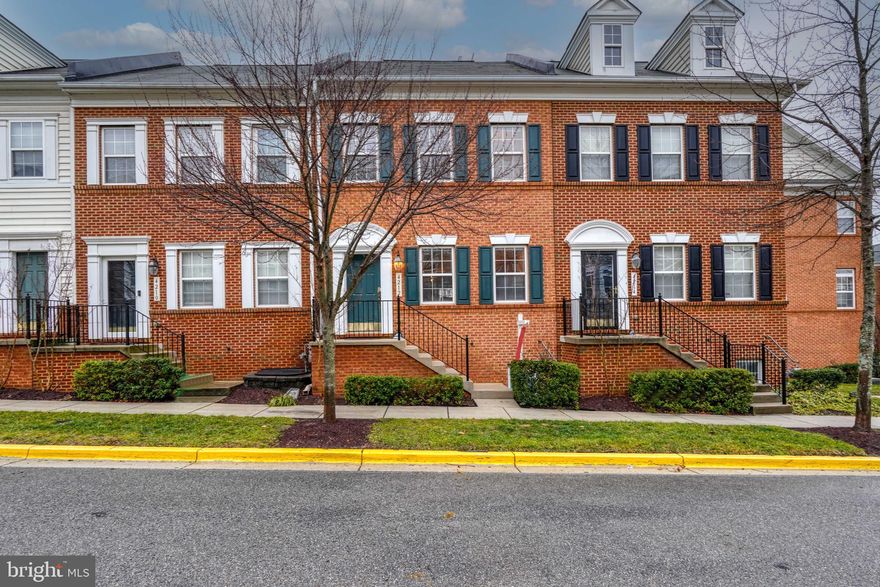 Welcome to your new lifestyle at 4212 Talmadge Cir! A gorgeous Brick-front home in the gated community of Camp Springs, a Freedom Series by Centex Homes. This residence spans three levels, offering three bedrooms and two and a half bathrooms. Walk-up steps to enter into a welcoming split-level foyer that leads to an open floor plan main level with gleaming hardwood floors. The main level is light and bright and has an open floorplan. The kitchen opens to a dining/family room with a cozy gas fireplace and opens to a trex deck. The kitchen exudes elegance with ample counter and cabinetry, gas cooking and solid oak cabinets.  Ascend the staircase to the bedroom level, featuring a primary suite with a walk-in closet with custom closet system, and an en suite bathroom. There are two additional bedrooms and a hall bathroom on this level. The fully finished basement level houses a recreation room and provides access to the garage. The oversized two-car garage has been outfitted with customer closet system, offering extra storage space. The Town Center at Camp Springs community, with gated access, includes common area maintenance, snow removal, and trash and recycling services in the monthly HOA fee. Conveniently located near Route 5, Suitland Pkwy, and the Branch Avenue Metro Station, this townhome combines sophistication, comfort, and convenience. Hurry – won’t last long!