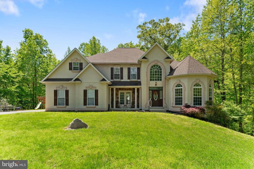 DRASTICALLY REDUCED !! Tucked away on a private cul-de-sac used by this home, this stunning property offers over 5,000 square feet of living space and incredible views. With five spacious bedrooms, four full bathrooms, and one half bath, this home truly has it all. The main level features an elegant owner’s suite with custom closets and a luxurious en-suite bath with a soaking tub. Gleaming hardwood floors flow throughout, complementing the formal dining room and the soaring two-story family room, which features dramatic palladium windows that flood the space with natural light. 

The main level features a gourmet eat-in kitchen with granite countertops, a convenient laundry area, and a powder room.  The expansive deck and backyard offer a tranquil view. The oversized driveway provides ample parking, and a side-load garage is also available. The cul-de-sac's privacy adds a rare touch of exclusivity. 

Upstairs is a second owner's bedroom featuring a sitting area, a custom closet, and an en-suite bathroom with a soaking tub. Two bedrooms, each with a full adjoining Jack-and-Jill bathroom, are also located upstairs. This home has it all!

The fully finished lower level spans over 1,900 square feet and has fresh paint, new carpet, and recessed lighting. It includes a fifth bedroom, a full bath, a laundry hook-up, and a show-stopping custom wet bar with a commercial-grade ice maker and a commercial-grade back bar refrigerator, seating up to 12 guests. Ideal as an in-law suite or income-producing rental space, this level offers endless versatility. The home has a radon mitigation system installed. The roof is under 5 years old.

This home is a dream for entertainers, offering space, style, and unmatched privacy. It is easy to show online with a showing time. The sellers would prefer to settle with Bridge Title.