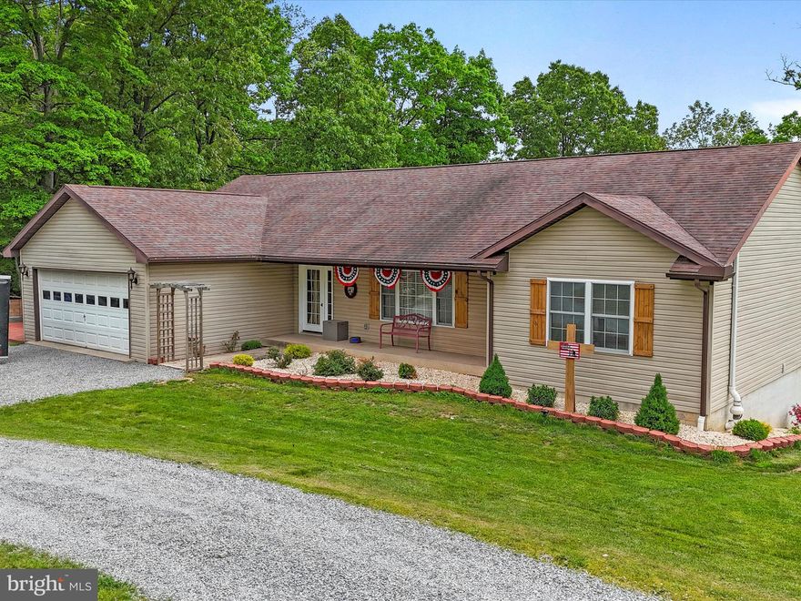 This remarkable home sits on 2.3 acres in lovely Augusta, WV. The home boasts new flooring and carpet throughout the main level and a recently remodeled kitchen and guest bathroom. A custom accent rock  wall in the living room will surely impress anyone visiting the home. The vaulted ceilings and open concept in the main living space has a comfortable setting for relaxing with family or entertaining friends. The great kitchen has ample storage, new stainless steel appliances and a kitchen island for food prep and seating. The main level of the home is easily accessible with a master bedroom that has an attached master bathroom. The washer and dryer are located just across from the master bedroom. The outdoor living areas include a covered front porch, a bonfire pit just outside the fully finished walk-out basement and a back deck that was extended for bonus space. The back deck boasts a new canopy and an excellent view of the back yard. The land that hosts the house has a nice front yard that sits back off of the paved road with a horseshoe driveway. The backyard has a cleared area off of the back of the house and then some wooded locations that offer an idyllic private place to escape and enjoy the fresh air and sun shining through the branches. The expansive finished basement has a full bathroom with washer/dryer hook-ups, hook-ups for a kitchenette, a hook-up for a pellet stove, and an enclosed custom trophy case. The finished basement could be a great space for an in-law suite. The attached garage has interior access from the main level and new garage door openers with smart phone options. The yard has invisible fencing for the four legged family members and a new Amish shed will convey with the property. The new hot water was installed in 2022. To top off everything that this lovely property has to offer, it is conveniently located to both Winchester, VA and Romney, WV.
