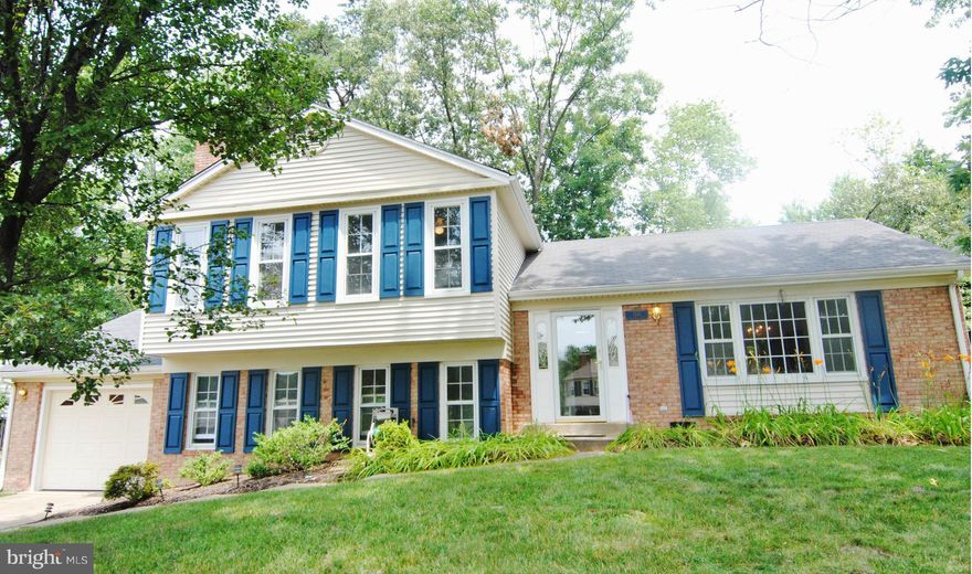 Updated kitchen with bay window, oak cabinetry, and recent appliances. Brand new carpet, fresh paint, chair rail molding, and new garage door. Floored attic. Walk-out lower level w/room for 5th BR, rear entrance, full bath, and large rec room with brick fireplace....loads of windows & light! Lovely rear yard setting with deck & patio, and nice treed view.
