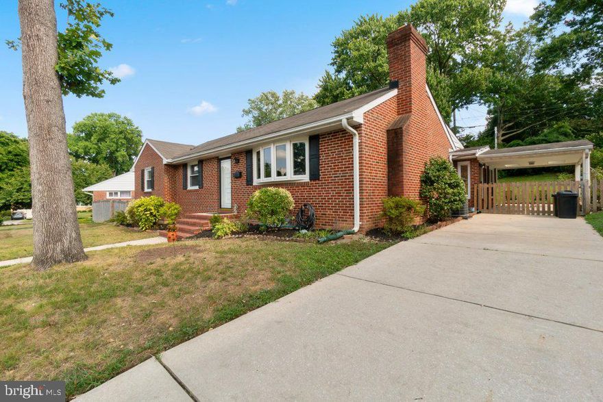 This charming all-brick rancher in Lutherville-Timonium, MD, features a spacious and thoughtfully designed layout with a large addition. The main level boasts beautiful wood floors throughout, creating a warm and inviting atmosphere. The expansive living room, complete with a cozy fireplace, seamlessly flows into an updated kitchen and dining area. The kitchen impresses with its tiled floor, granite countertops, and stainless steel appliances. The generous family room addition provides ample extra space and includes a separate room perfect for use as a pantry with enough space for a second refrigerator, offering excellent storage solutions. The home includes three comfortable bedrooms and two and a half baths, with the large, carpeted basement offering additional living space and a full bath. The basement also features separate areas for storage, laundry, and utilities.  Don't miss the large cedar closet  close to the laundry., perfect for hanging and storing your best clothes and important accessories.     Outside, a large driveway leads to a convenient covered carport and porch, ensuring easy and rain-free entry to the home. The fenced-in backyard provides a private outdoor retreat, ideal for relaxation or entertaining. This home combines comfort, convenience, and ample storage in a super desirable location.
