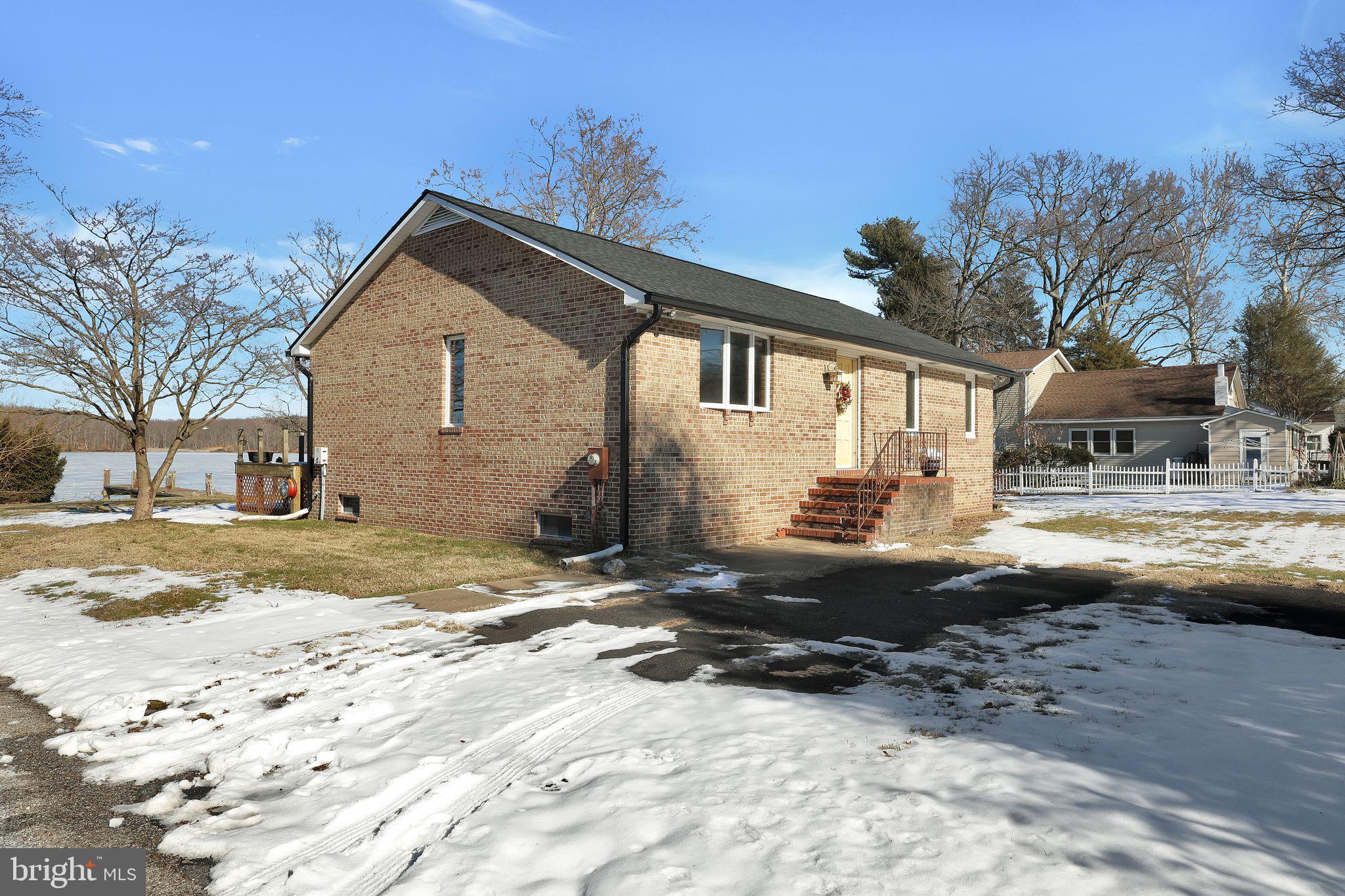 Great Opportunity For WATERFRONT LIVING!! This serene retreat offers breathtaking views and direct access to the water with a private pier, perfect for enjoying sunrises, kayaking, or simply unwinding by the shore. Set on a spacious 0.63-acre lot, the home features a detached garage ideal for vehicle/boat parking, additional storage, or a private workspace! Whether you're entertaining guests or seeking a quiet escape, this property is your gateway to a life of tranquility and adventure. Don’t miss the chance to own your slice of waterfront paradise! **Roof on home & garage was replaced in 2024**