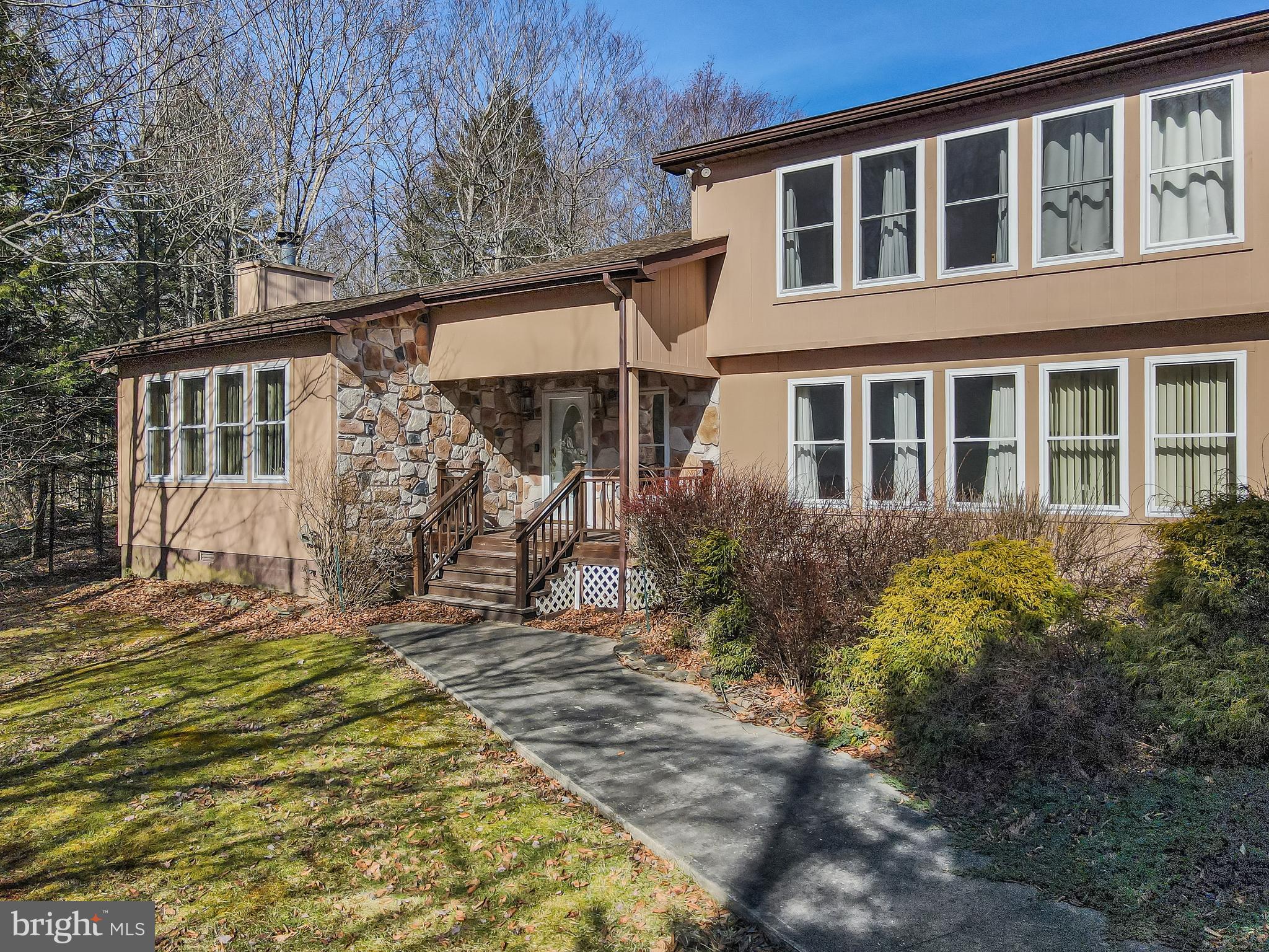 Nestled in the heart of the picturesque Pocono Mountains, this expansive 4,100 sq. ft. home in Lakeview Estates offers the perfect blend of space, charm, and opportunity. Boasting 4 bedrooms and 3 baths, this property is a dream come true for those who love to entertain or seek a tranquil retreat close to nature. Its prime location places you just a short stroll away from a stunning lake. Set on almost 2 acres of land, the home features outdoor delights like a 34' bocce court, ideal for gatherings and relaxation. The oversized 1,200 sq. ft. 6-car garage and workshop offer incredible functionality for hobbyists and car enthusiasts alike. Inside, the house exudes potential with its spacious layout. Highlights include a living room with soaring vaulted ceilings and a striking floor-to-ceiling stone fireplace, as well as a grand family room with 12' ceilings and its own cozy fireplace. A dedicated office/den adds versatility, while the master suite provides a private sanctuary complete with a luxurious soaking tub. Though the home requires some updating, it's priced accordingly and is being sold 'as is,' making it an exceptional opportunity to customize and create your perfect haven in this charming mountain town. A little love and vision could truly make this gem sparkle!