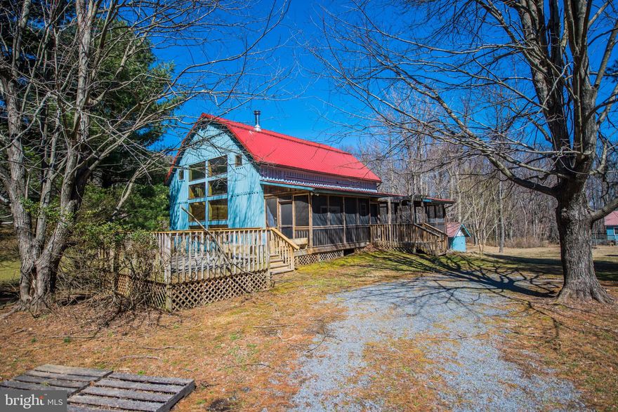 Have you ever wanted to live in a  repurposed barn? Come take a look at this 3.34 acres close to Historic Berkeley Springs, and minutes to Cacapon State Park.  Fenced garden area, large open decks, 2.5 levels of living area.  An additional well maintained building for artist studio. Potential for pond. Two large open decks and spacious screened porch invite you to enjoy the outdoors.