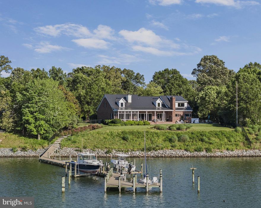 Experience one of the most spectacular views on Carter’s Creek from this charming 4,376 sq. ft. brick transitional home. Thoughtfully designed for both relaxed living and elegant entertaining, this 4-bedroom, 4.5 bath home features an open floor plan cen-tered around a stunning gathering room and kitchen, seamlessly flowing into a dining area. Soaring 10-foot ceilings, heart pine floors, and oversized windows flood the space with natural light and frame the incredible water views.  The waterside owner’s suite offers a private retreat with panoramic views, a spacious walk-in closet, and an ensuite bath. A cozy den, ideal as a home office, completes the main level. Upstairs are three generously sized bedrooms, two full baths, and abundant storage providing spacious comfort. The attached two-car garage adds practicality. Outdoor living shines here with a screened porch, a covered  porch with built in grill, a heated salt water pool surrounded by travertine pavers and accented by a lighted fountain. Set on a 1.799 acre site that is beautifully landscaped with irrigation, the property offers privacy, se-renity, and unbeatable sunsets.  For boaters, the deep-water dock with 10 feet MLW, two boat lifts, a floating dock, electricity, and water is perfect for any vessel seeking a protected harbor. Located on one of the Northern Neck’s premier waterfronts , you will find breathtaking views and unforgettable sunsets—a true gem—this is truly a remark-able opportunity.