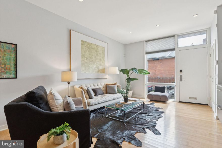 Set on a lush, tree-lined block in the heart of the Graduate Hospital Neighborhood, this striking 3-bedroom, 2.5-bath home offers the perfect balance of bold modern design, refined finishes, and effortless city living across four expansive levels. Limestone steps lead to a dramatic main floor anchored by a custom living and dining space with built-in entertainment center, decorative fireplace, oversized coat closet, and solid birch hardwood floors throughout. High ceilings and recessed Lutron lighting amplify the scale and ambiance while a mid-century inspired chandelier provides a focal point for the dining space. The chef’s kitchen is a true centerpiece, featuring walls of custom cabinetry flanking a central island, expansive Caesarstone countertops, Sub-Zero and Wolf appliances, and offering direct access to a serene bluestone patio garden—ideal for entertaining or a quiet morning retreat.
The second floor features generously sized front and rear bedrooms with fully built-out Elfa closets, a European-style bath with separate glass-enclosed shower and soaking tub, and a full laundry room with side-by-side washer and dryer, upper cabinetry, and folding station. The full-floor primary suite crowns the home with a spa-like bath boasting a double walk-in shower, dual Elfa-fitted walk-in closets, a sitting and vanity area, and a wall of windows with sliding doors opening to a Trex roof deck with panoramic Center City views—your private oasis above the city.
The finished lower level offers flexible bonus space, perfect for a media room, office, gym, or playroom, with imported tile flooring, custom California Closet built-ins, and a separate mechanical room. Additional upgrades include recessed lighting, dual-zoned central HVAC, and thoughtful storage throughout. Located within the sought-after Greenfield School catchment and just minutes from CHOP, HUP, Penn, and Drexel, this home is also surrounded by neighborhood staples like Loco Pez, Ants Pants, Sabrina’s, City Fitness, Heirloom Market, and so much more. This exceptional residence places you at the center of it all—where architectural excellence meets everyday convenience and ease. Come for a tour today!