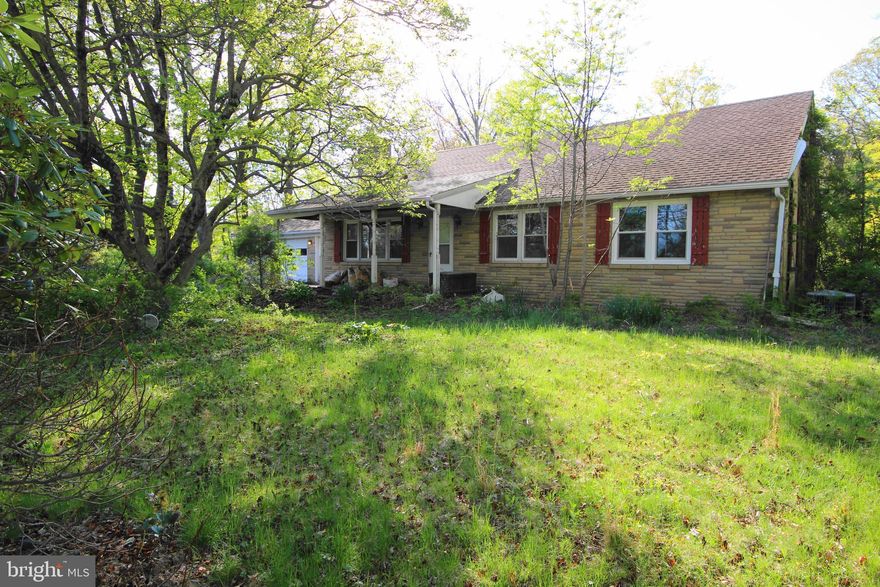 What a find!  5 bedroom single on 2 acres in Pennridge School District! Enter through the  sunroom into the generous sized kitchen with island and plenty of cabinet space.   Spacious living room with fireplace complete with wood burning insert.  Three  bedrooms on main level and full bath with walk in shower.  Hardwood floors will look great when refinished!  Screened-in porch off kitchen to relax and enjoy your surroundings.  Upstairs you will find 2 large bedrooms with walk-in closets and hall bath complete with shower and soaking tub.  New sand mound in 2014.  New well during ownership.  Replaced all water lines in the house April 2026.  Plenty of space in the basement for finishing.  Over sized 2 car garage.  Close to major routes of travel, shopping and restaurants.  Bring your paintbrush and ideas and enjoy this house with beautiful, serene lot.