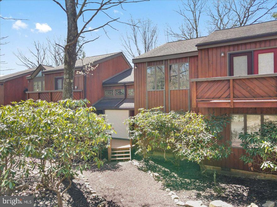 OPEN HOUSE 4/18, 1-3pm! Short-term rental friendly 3BR / 2BA mountain chalet in the Blue Heron Community near Big Boulder Ski Area and Big Boulder Lake. Rustic-modern interior with stone accents, wood-burning fireplace, and stylish furnishings. Open-concept living, dining, and kitchen with access to deck. First floor includes 1 bedroom and full bath. Second level features 2 spacious bedrooms and a full bath with soaking tub and separate shower; one bedroom offers a private balcony. Optional membership to Boulder Lake Club provides pool, beach area, and watersport rentals. Ideal for vacation home, investment property, or year-round living.