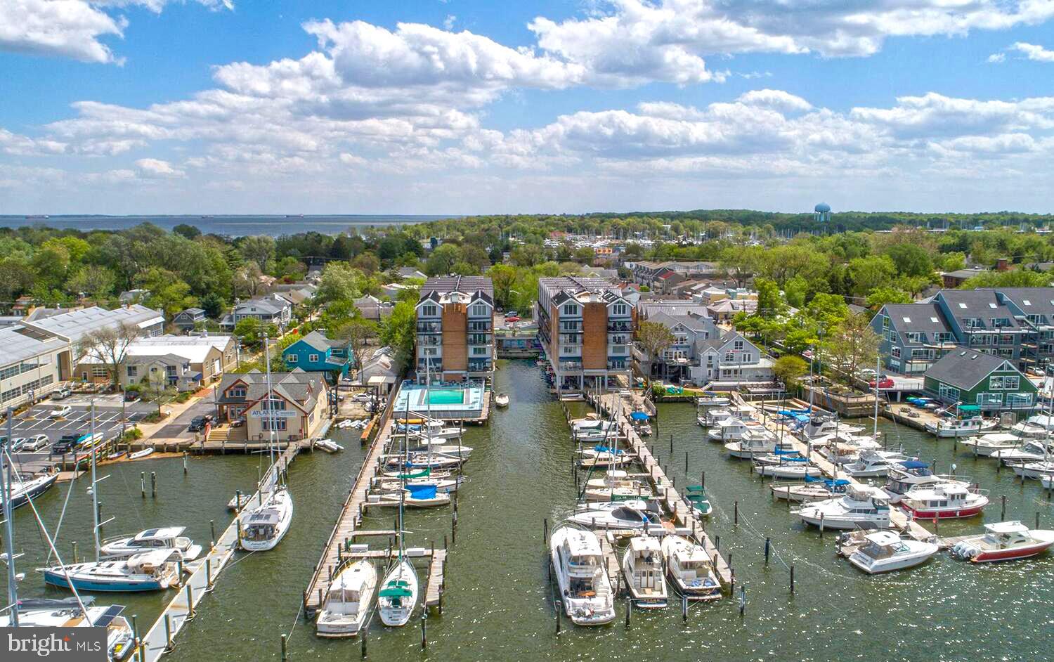 Location! Location! Location! Perched on the top floor of The Tecumseh—Maryland’s first condominium building—this rarely available two-level loft offers water views, thoughtful updates, and an unbeatable Eastport lifestyle and access to all the charm and excitement of coastal living in Annapolis. W401 overlooks Spa Creek with views of Ego Alley, the community marina, and Severn Avenue. This 1-bedroom, 1-bath unit features an open-concept main level with living and dining areas, a well-equipped kitchen, mechanical room, and closet, while the loft-style upper level with exposed beams includes a spacious bedroom with two closets and full bath with soaring ceilings and abundant natural light. Recent improvements include fresh paint, new carpet, and bathroom flooring (2024), a new refrigerator (2022), new HVAC system (2018), and a dishwasher and building-wide roof replacement (2017, assessment paid in full). This unit also includes a 19’ boat slip entitlement in the private marina—an exceptional feature for boaters. Community amenities include a gated parking lot, waterfront pool and deck on Spa Creek, private marina, kayak/canoe rack, bike and sail storage, on-site property manager and custodian, pet-friendly policies, secure entry with elevator access, lobby with kitchen and mailroom, and convenient laundry and trash facilities on each upper floor. The Tecumseh Condominium is in THE heart of Eastport, just steps from acclaimed restaurants, local shops, museums, and waterfront attractions, with easy access to downtown Annapolis by foot, bike, or water taxi. Don't miss this opportunity to own in one of Eastport's most sought-after waterfront condominium communities. Welcome to The Tecumseh – Eastport Living at Its Best.
(The Tecumseh Condominium has a 15-day first right of refusal.)