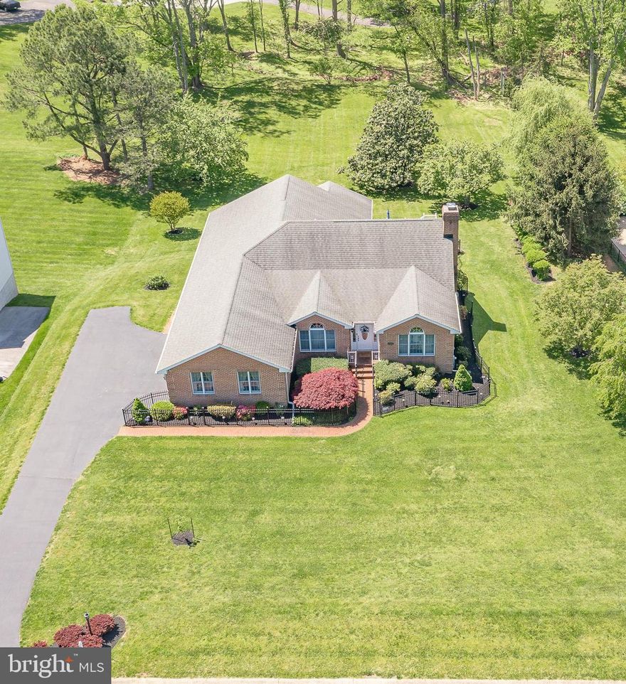 Welcome to this absolutely gorgeous all-brick rancher, boasting of a classic appeal yet with modern improvements throughout for an ideal combination. Past its stately front elevation and immaculately-maintained front lawn and landscaping, you are welcomed into a bright entry foyer that flows effortlessly into the home’s formal living and dining rooms. Flooded with natural light to complement the gorgeous hardwood flooring, this layout is ideal for entertaining any number of guests in its gracious, accommodating room sizes. Make your way into the kitchen, which features abundant cabinet and counter space and boasts of an airy cathedral ceiling that continues into the adjacent family room. You’ll love enjoying evenings with friends in this exceptional space, with its slider leading to the expansive back deck and yard for a breezy indoor/outdoor flow. Enjoy relaxing in the generously sized primary bedroom suite with a soaring ceiling, plenty of natural light, a sitting area, walk-in closet, and private bath! The three secondary bedrooms are spacious and allow for any number of easy configurations. The finished walk-out lower level provides an enormous amount of space to suit your needs, with a rec room, half bath, flex space, and plenty of storage. This home is completed by its expansive rear deck, boasting of serene views of the large rear yard studded with mature trees. With a fabulous location in Ellicott City that is peaceful and private yet convenient to every major amenity you could need, this one has it all.