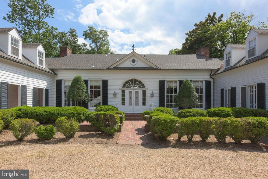 Rare and Remarkable,  Arch Hall is located on a magnificent waterfront parcel of nearly 9 acres overlooking the waters of Belmont Bay, where the Occoquan River joins the Potomac.  Originally located in Alexandria, as the home of George Washington's nephew, Major Lawrence Lewis, and Eleanor Parke Custis, the granddaughter of Martha Washington, Arch Hall was removed and rebuilt in its present location in 1950-1951.  Since then it has had several thoughtful and complementary additions, respecting the classical elements of this 18th century gem.  Gracious, light-filled rooms are highlighted by mellow wood and period details, throughout.  The house offers over 5,000 sf of living space on two levels. The main level features high ceilings and generous room sizes.   A first floor wing is devoted to a primary suite with a bedroom,  full bath and private study. The upper level includes five bedrooms and three full baths and additional storage. 

Awaiting its next chapter, Arch Hall conveys in "As Is" condition.  The main roof has been recently replaced; many of the systems are older, though regularly maintained.

This entire property, including the main house, out buildings and nearly 9 acres,  is  protected by an historic and conservation easement.  Subdivision is prohibited, but the property is magnificent as-is.