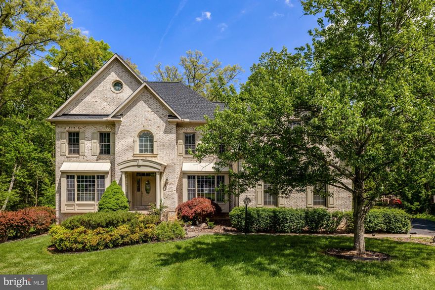 Stately 3 sided-brick colonial situated on a 1-acre lot in a quiet cul-de-sac. A grand foyer welcomes you, showcasing detailed woodwork and character throughout. Hardwood and ceramic tile flooring add timeless appeal across the main level. The generous living room flows into a formal dining room—perfect for entertaining. A private office with French doors provides a quiet, dedicated workspace.
The heart of the home is centered around the kitchen, sunroom, and family room—all offering beautiful views of the wooded backyard and easy access to the rear deck. The sunroom, perched above the landscape, feels like a treehouse retreat with natural light and treetop views from every angle. In the adjacent family room, a cozy gas fireplace anchors the space, perfect for relaxing evenings or entertaining guests.
Up the curved staircase, the upper level offers a luxurious and private retreat. The spacious owner’s suite includes vaulted ceilings, a gas fireplace, two sitting areas, a dressing room with built-ins, two additional walk-in closets, and a large en-suite bath with dual vanities, a soaking tub, and a glass-enclosed shower.
Additional bedrooms include one with a private en-suite bath and two others connected by a shared “buddy” bathroom. A three-car garage offers generous storage and parking.
The unfinished walk-out lower-level features full-sized windows and 9 foot ceilings—ready for you to transform into additional living space, a home gym, theater, or whatever suits your vision.
Conveniently located near Route 7/Leesburg Pike, Reston Town Center, Reston Metro stations, and Tysons Corner.
