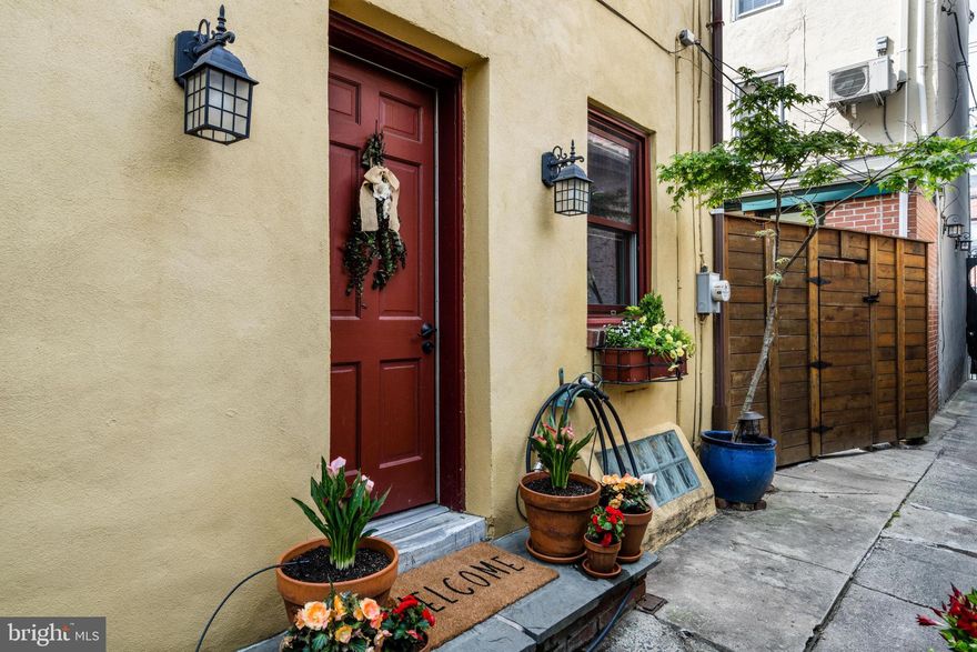 Tucked away in the heart of Fitler Square, this charming 2 bed, 2-bath, plus den, home offers privacy and modern updates. Set back from Naudain Street down a quiet path, this hidden gem greets you with lush plantings, window boxes, and a convenient outdoor shed perfect for bike storage. Inside, the open living and dining area is warm and inviting, featuring hardwood floors, recessed lighting, and a built-in bar ideal for entertaining. French doors lead to a spacious and private backyard - your own urban oasis. The updated kitchen includes stainless steel appliances and ample cabinetry, flowing effortlessly into the main living space. Upstairs, the second floor offers a bright bedroom, an expansive fully tiled full bath, and an additional bonus room—perfect for a nursery, office, or den. A washer and dryer complete this level. The top-floor primary suite features another fully tiled bathroom with an oversized walk-in shower, and direct access to a custom Trex roof deck with skyline views. The basement provides storage and a flexible finished area ideal for a home office, gym or playroom. Located in one of Philadelphia’s most sought-after neighborhoods, this home is walkable to PENN, CHOP, Rittenhouse Square, and Center City, with neighborhood favorites like Cafe Lutecia and Rival Bros just around the corner. A rare opportunity to own a truly special home.