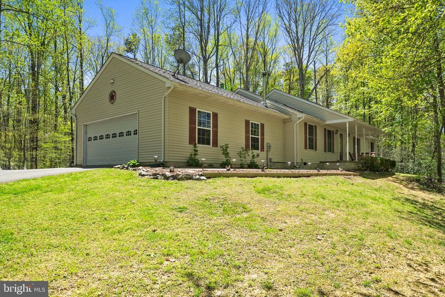 Welcome to this beautifully maintained 3 bedroom, 2.5 bath rambler nestled on over 3.5 private acres with no HOA! Enjoy a spacious and updated kitchen featuring stainless steel appliances, a center island, and plenty of cabinet space, perfect for the cook at home. Entertain in the formal dining room or relax in the cozy family room with vaulted ceilings, skylights and wood stove. The home offers a desirable one-level layout, a 2-car attached garage, plus a separate shed for additional storage or workshop space. Step outside to a peaceful setting with a welcoming front porch, a multi-level rear deck perfect for gatherings, and a level backyard that backs to mature woods for added privacy. Don’t miss this rare blend of comfort, convenience, and seclusion—schedule your tour today! Updates include roof (2021), water heater (2019), heat pump (2022), and skylights.