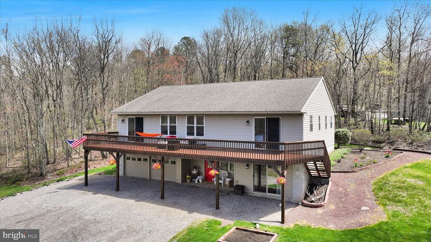 Welcome to your private mountain retreat! This spacious 4-bedroom, 3-bath home  provides a rare opportunity to buy in the beautiful Lewistown Valley! The home offers breathtaking panoramic views that stretch for miles — with sunrises from the back deck and sunsets from the front. Set on a beautiful acre-plus lot above the scenic Lewistown Valley, you’ll enjoy the peace and privacy of country living while still being just minutes from schools, shopping and everyday conveniences. Inside, the raised ranch design maximizes space and functionality. The main level features an open-concept kitchen, dining and living area with a pellet stove for added warmth and energy efficiency — perfect for entertaining or gathering with family. The primary suite includes a full bath, abundant natural light and private access to the expansive front deck, which runs the full length of the home. Two additional bedrooms and a large full bath with dual vanity complete the main floor. The finished lower level offers incredible flexibility, with a cozy sitting room or office, a spacious rec room with custom wet bar and beautiful hardwood floors, and a fourth bedroom with private bath featuring a walk-in shower with bench — ideal for guests, teens or a potential in-law suite. A split driveway provides on-grade access to both the main and lower levels, enhancing accessibility. You’ll also find additional storage space, a utility area with sink and an attached two-car garage. Outside, enjoy multiple outdoor living spaces, including the large front deck, a shaded rear deck perfect for relaxing or grilling, and a generous yard. A 14x8 barn-style shed with loft provides even more storage for tools and equipment. Located in the sought-after Tamaqua Area School District — including eligibility for two years of free tuition at Lehigh Carbon Community College — this home has been meticulously maintained and reflects true pride of ownership. Schedule your showing today and experience mountain living at its best.