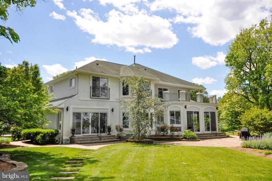 Spectacular waterfront home completely remodeled top-to-bottom in 2017.   Overlooking Columbia Cove and the Chesapeake Bay, this open and sunbathed home offers panoramic views for miles.   Like new this home features high-end appliances and fixtures throughout. The main level offers views of the Bay from every room, a wonderful  two-story foyer, living room with gas fireplace, gourmet chefs kitchen with top-of-the-line stainless steel appliances and island with bar seating, family/sunroom, main level master bedroom suite.  The main level is completed by a powder room, laundry/mud room, and spacious 2 car garage.   Upstairs features a second master bedroom suite with terrace overlooking the bay, 3rd bedroom with en-suite bath, a 3rd and 4th bedroom with jack-and-jill bath, and a open landing ideal for office or 2nd family room.    The rear yard features outdoor entertainment area with bar and 6-seat glider, extensive landscaping, 100+ feet of water-frontage, seawall, and a large pier.  17KW whole home generator.  Perfect for either full time residence or a weekend home.  Less than 45 minutes from downtown DC, Annapolis, and Virginia